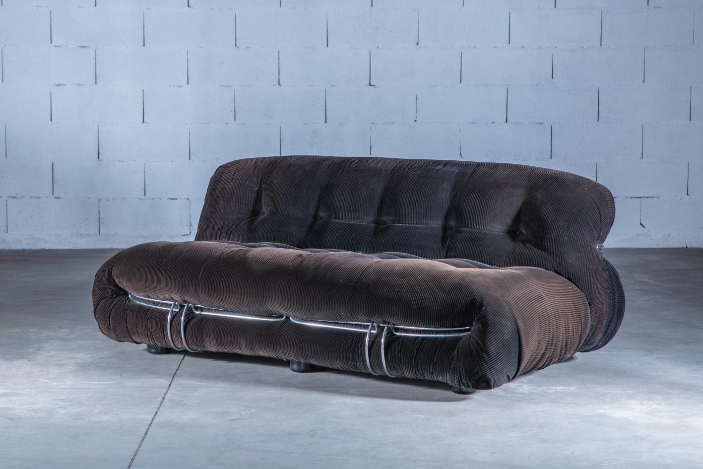 A two-seat ‘Soriana’ sofa, designed in the 1970s by Afra and Tobia Scarpa and produced by Cassina. Chromed metal rod structure and original courdroy fabric and makers label intact. The fabric shows wear and minor damage (see final photo) which is