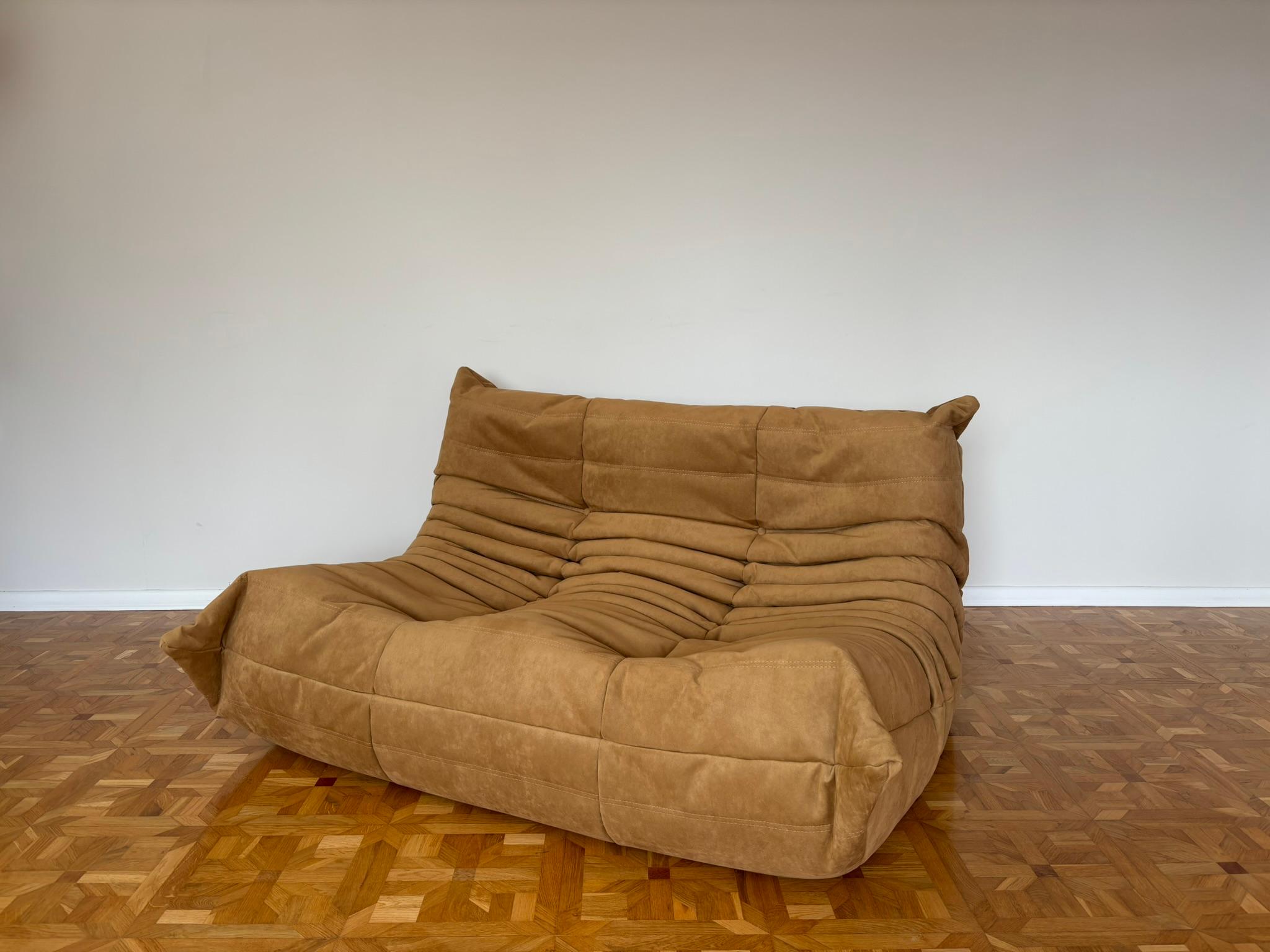 The Togo was designed by Michel Ducaroy in 1973 for Ligne Roset. It is the first sofa/chair ever made only of foam and leather. The collection features an ergonomic design with polyether foam construction and padded covers, making each piece both