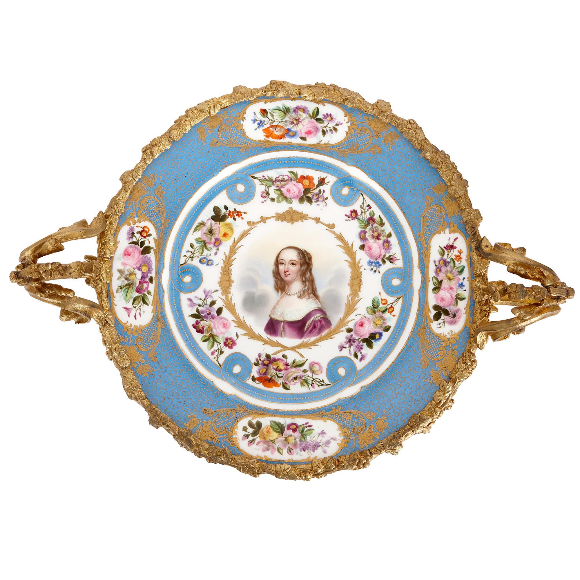 These beautiful mounted plates were crafted in circa 1830 in France. Designed in the Sevres style, the porcelain plates have been finely painted and set within elaborate gilt bronze mounts. 

At the centre of the plates’ painted decoration are