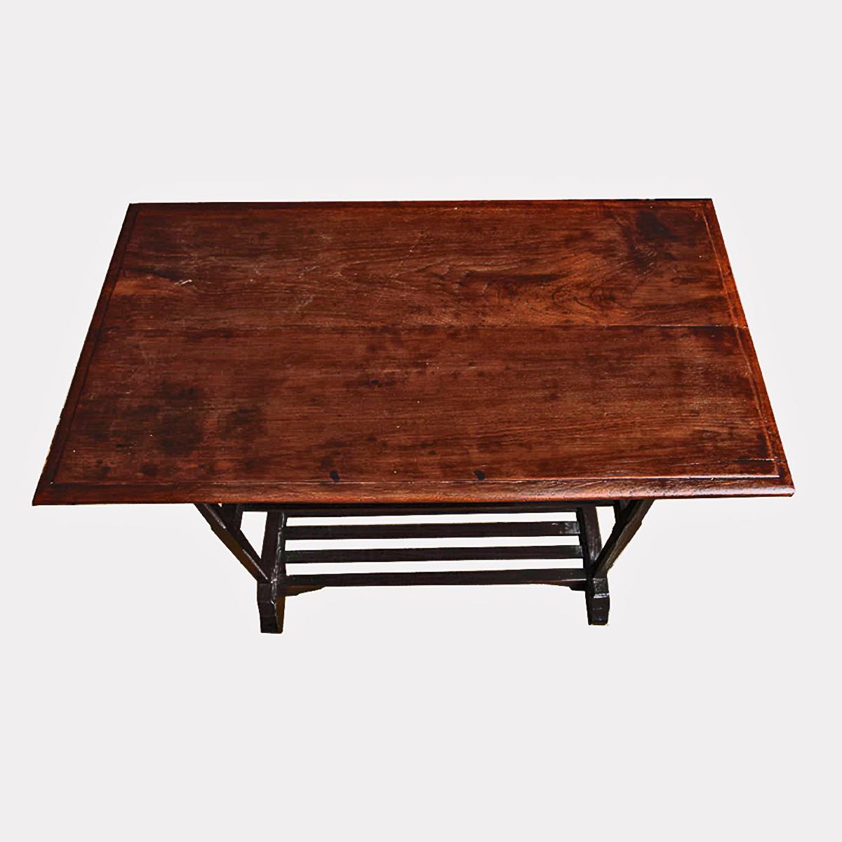 A table with two lower shelves from Thailand. Finished in two types of wood, this versatile table offers many possibilities as a utility table for a kitchen, a bedroom or any other room where additional storage is needed.