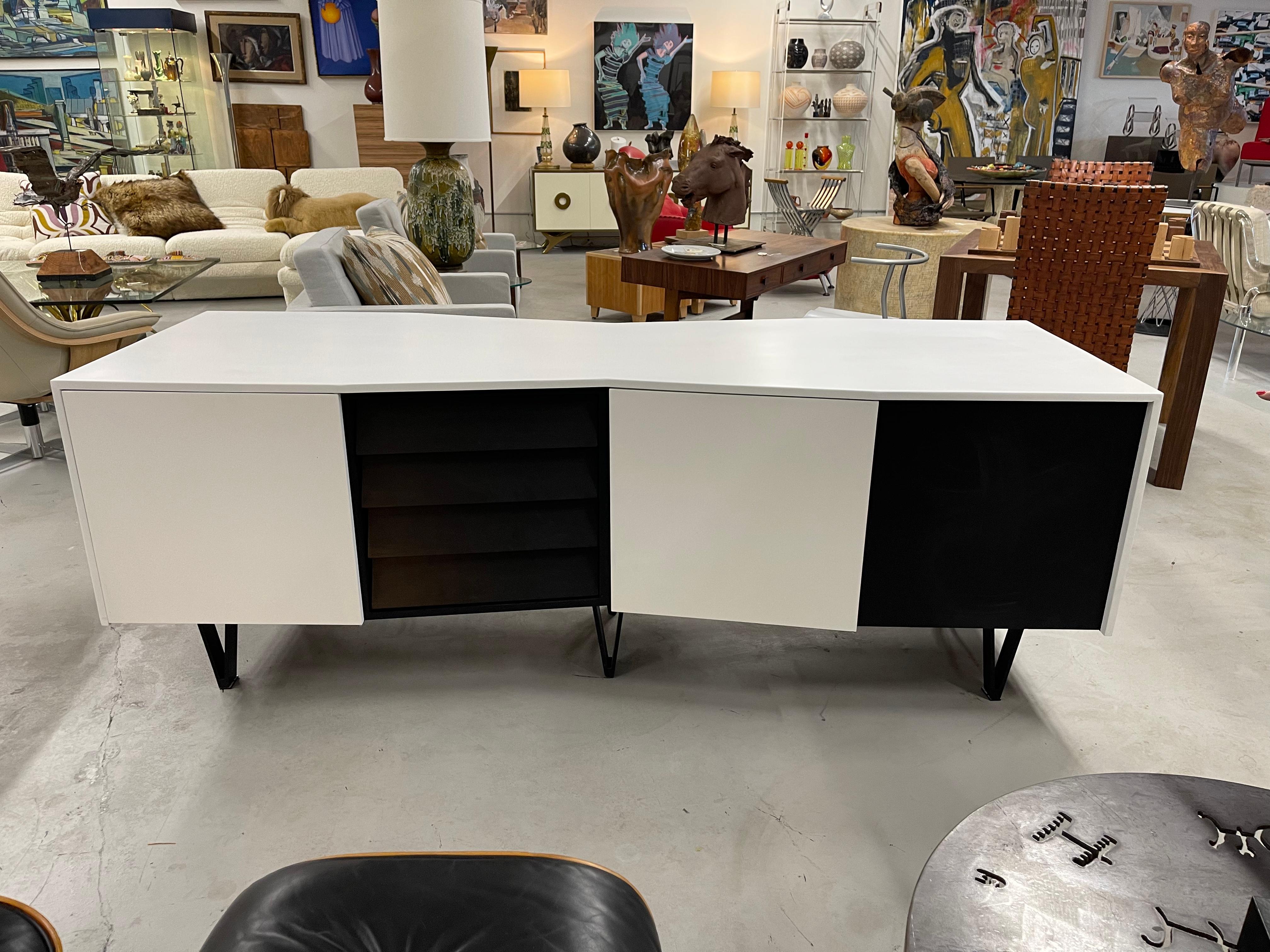 A spectacular 2 sided credenza with an angled shape. Each side has 10 drawers with two doors that can 