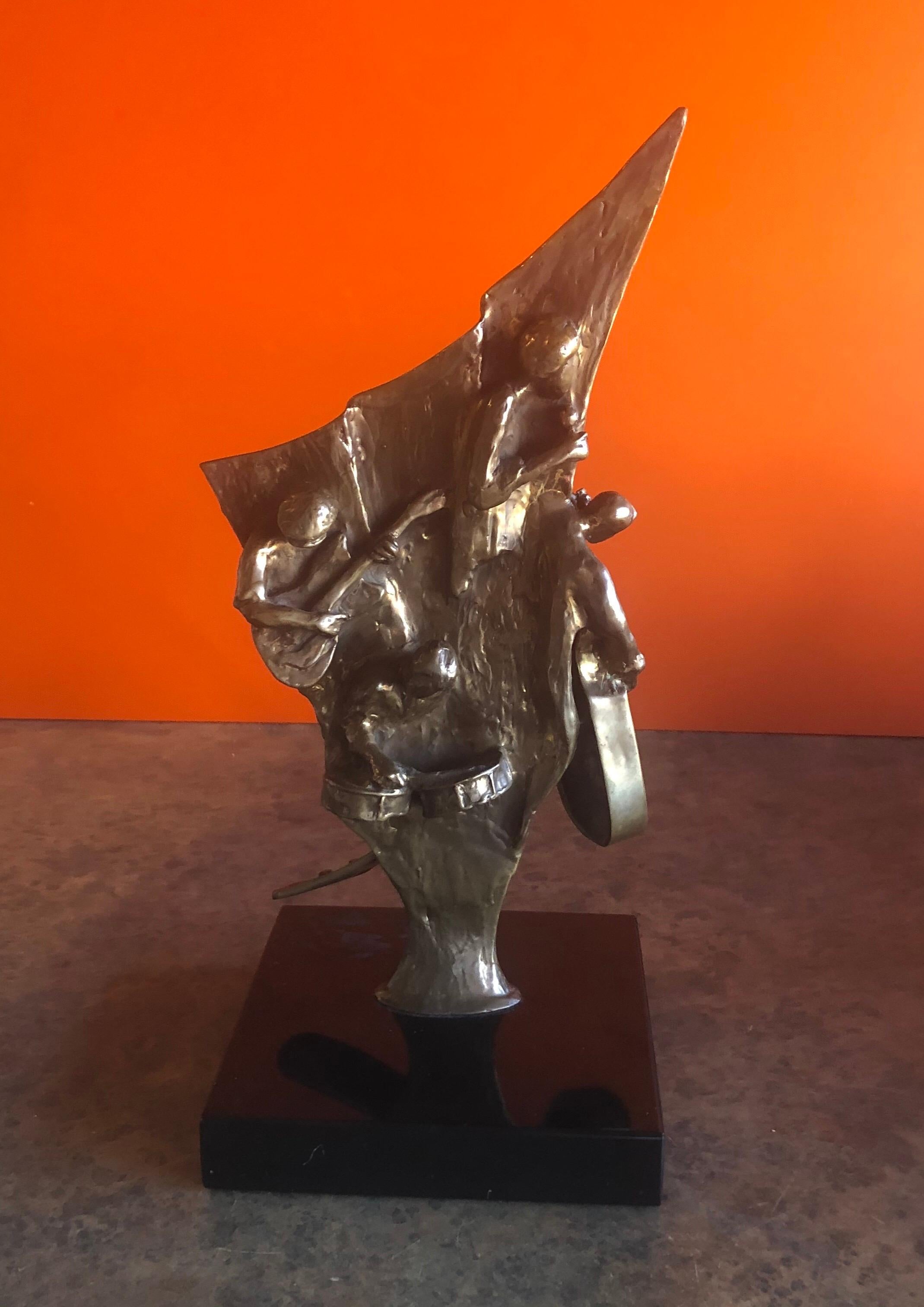 A very unique two sided bronze jazz musician sculpture on a black marble base by Ed Dwight, circa 1990s. The piece depicts six jazz musicians playing in concert (guitar, drums, lead singer on the front side; a sax, trumpet, bass and keyboard on the