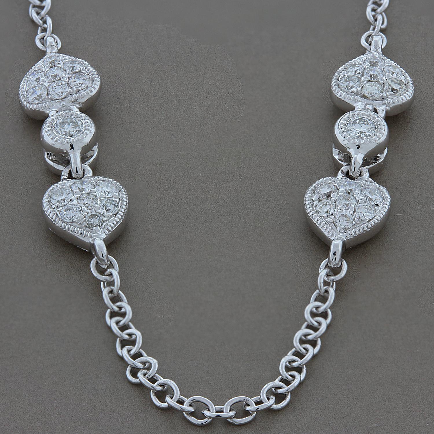 Two of Hearts! A diamond by the yard style necklace with diamond studded hearts. 2.06 carats of round VS quality diamonds are set in 18K white gold. The diamonds are set on the two sides of the hearts for a glisten with every turn.

Necklace Length: