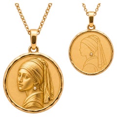 Collana con ciondolo a forma di ragazza con una perla, reversibile.
