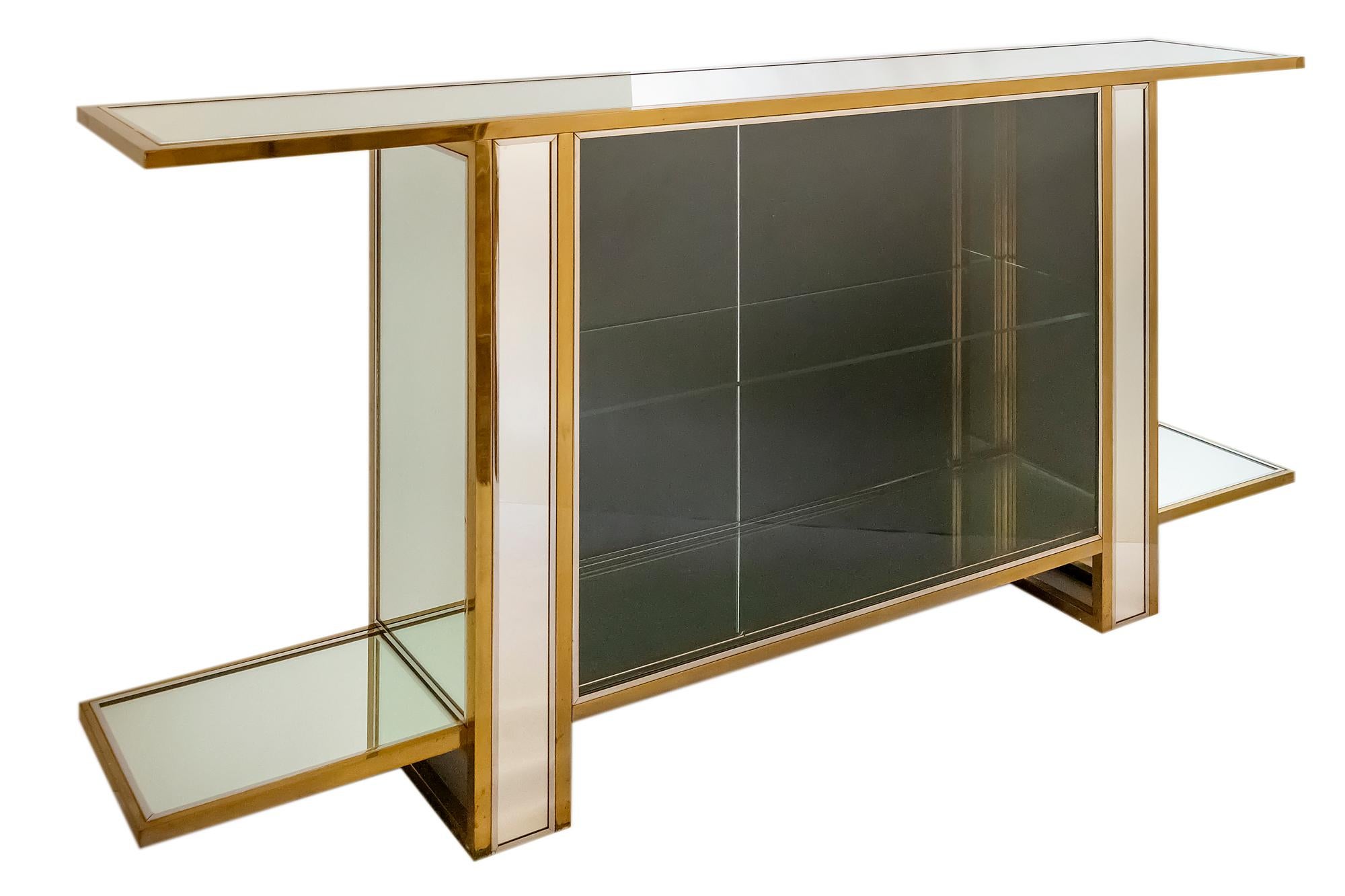 Midcentury mirrored two sided console - vitrine in brass, chrome and clear glass. 
One side with mirrored two doors, other side with glass. Inside - glass shelve. 
It is very heavy and stabile.