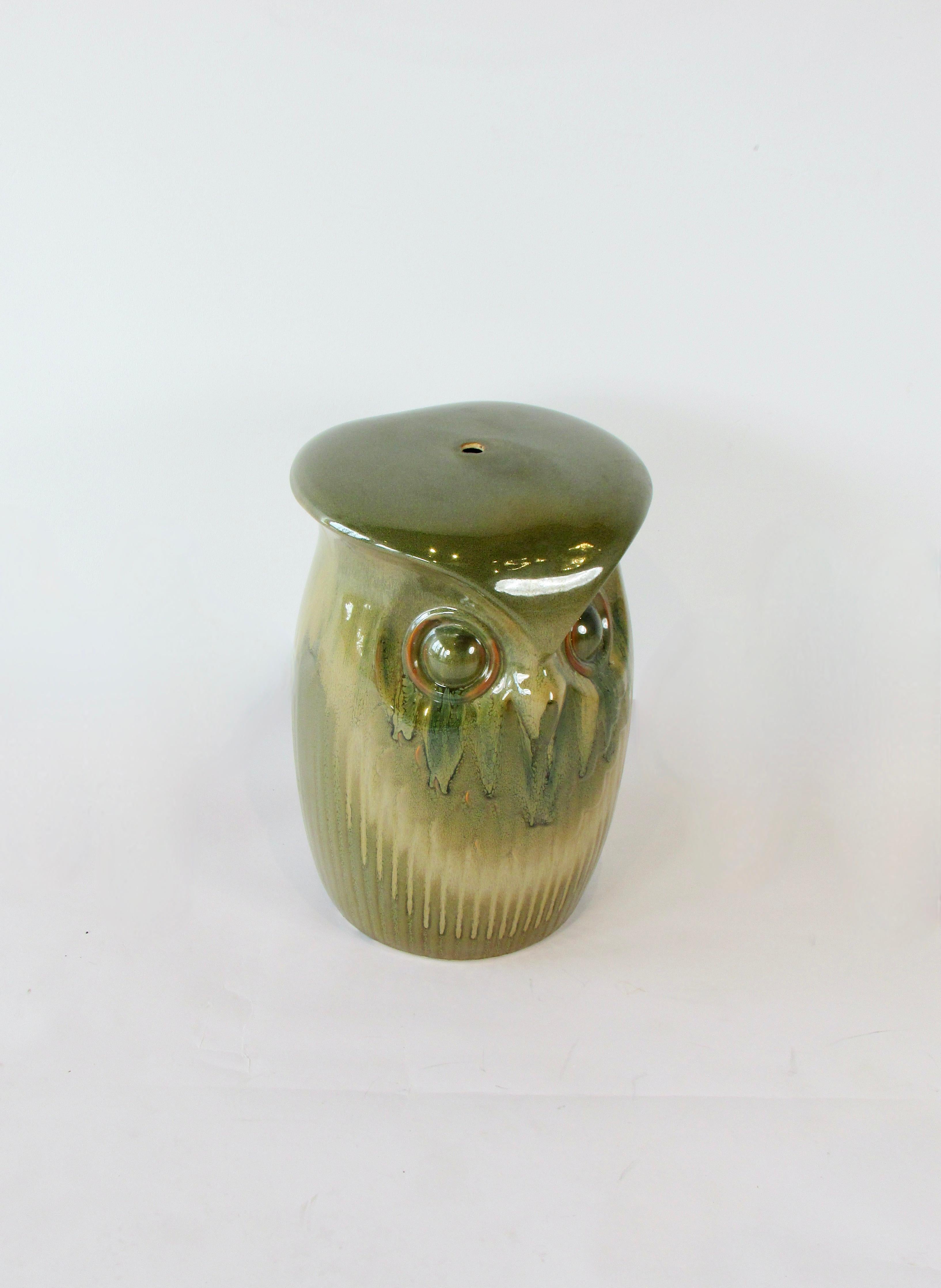 Beautifully glazed garden bench or stool with the face of an owl on either side.