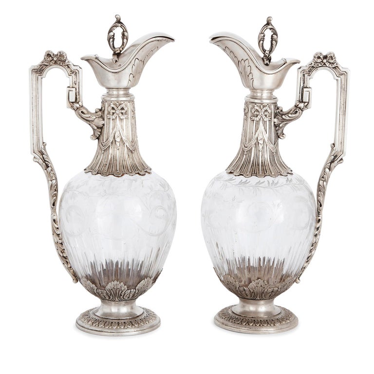 These elegant silver and glass claret wine jugs bear the maker’s marks for Armand Gross. Gross was an accomplished silversmith, active in France in the late 19th and early 20th Century. These silver claret jugs will make wonderful additions to a