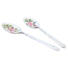 Two silver teaspoons with enameled floral shells and relief handles