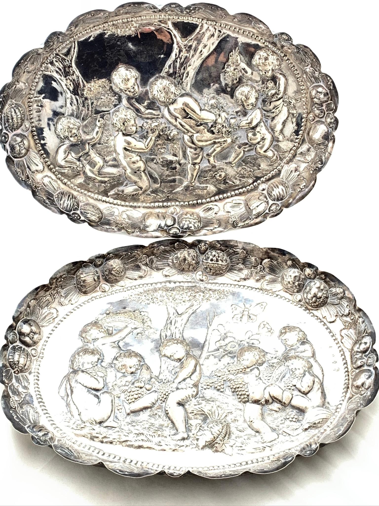 Two Silver Trays

Couple silver trays with a scene of little boys in a vineyard.
From the 18th century, in Nuremberg, Germany. 
Total weight: 705 grams