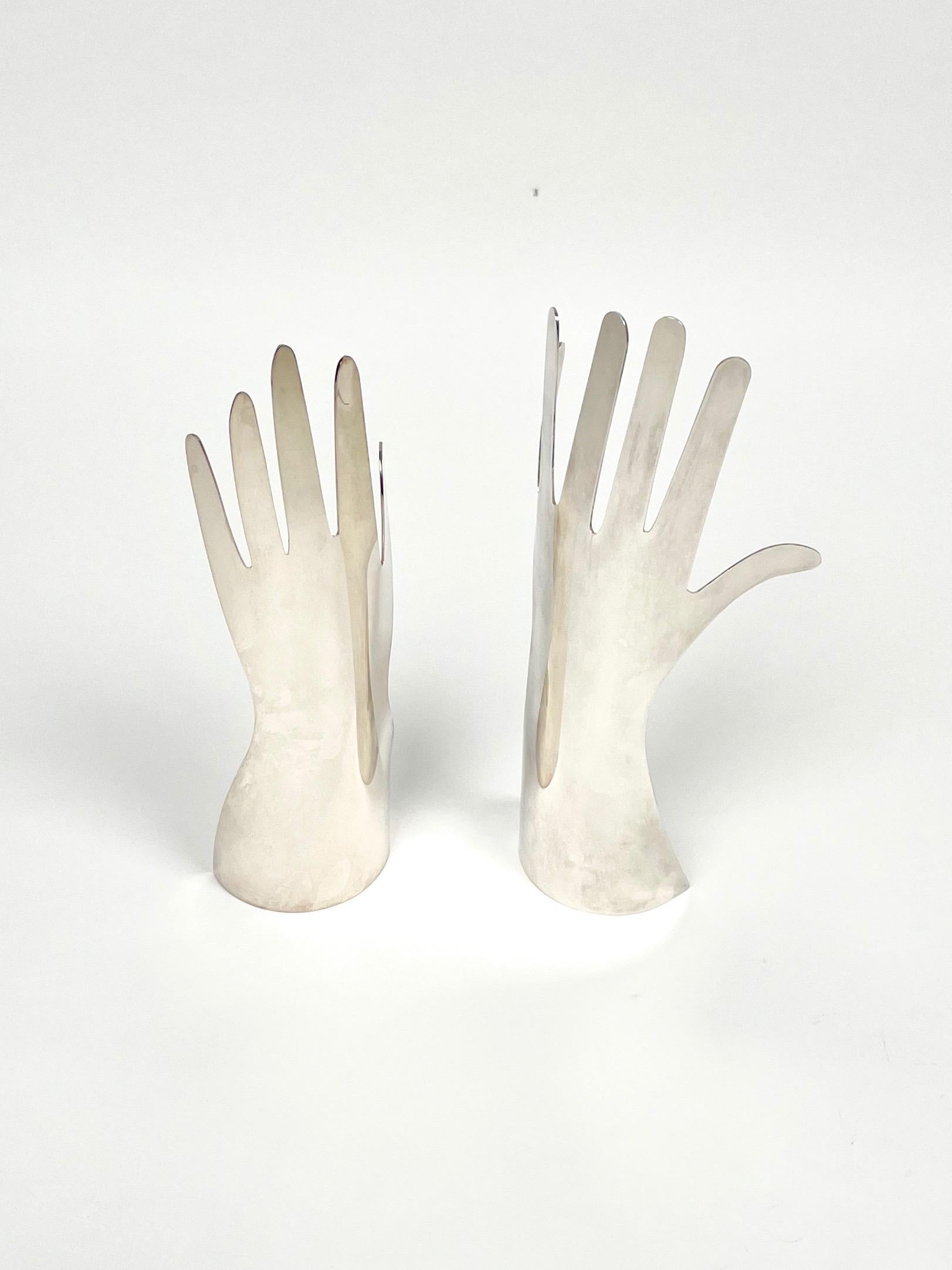 Le Mani or the hands. A silver metal sculpture of two hands designed by Gio Ponti for Sabattini. One hand with 5 the other with 6 fingers. 

Made in Italy in the 1970s.