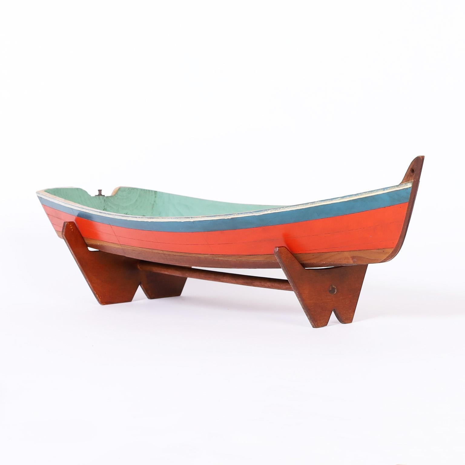 Pair of similar flat hull motor boat models hand crafted with mahogany, retaining their original paint and presented on custom wood stands. Priced individually. 

Measures: Front Model- H: 6 W: 21.5 D: 7.5 $1,500
Back Model- H: 7 W: 27.5 D: 7.5