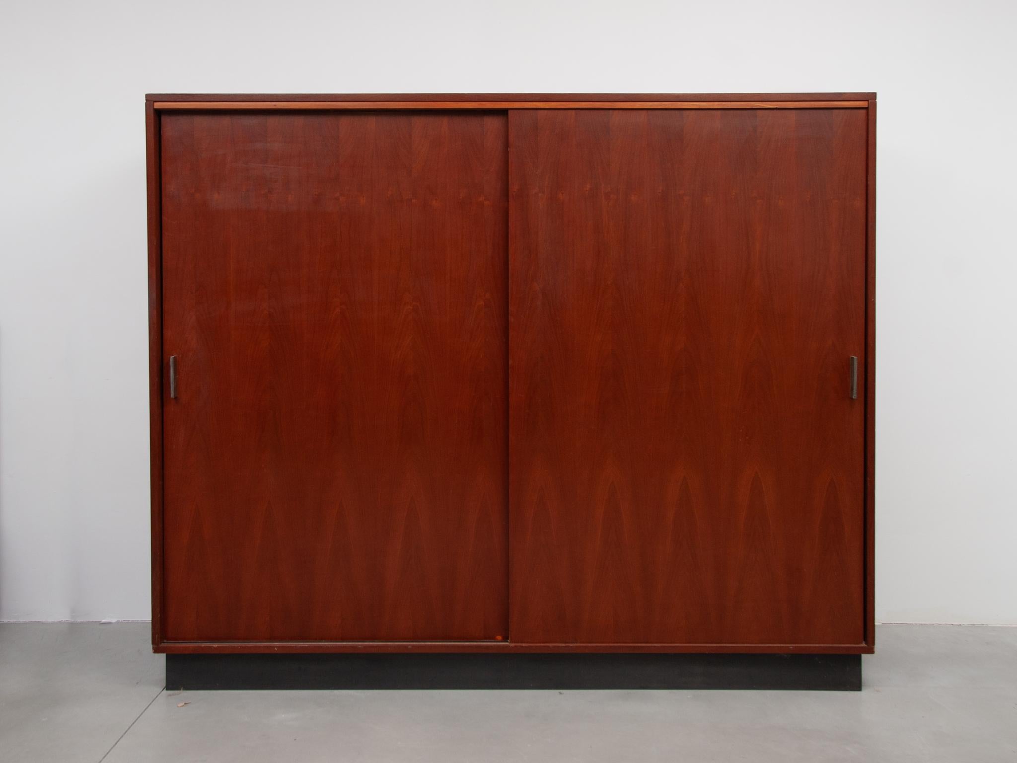 Beautiful wardrobe designed by Belgian designer Alfred Hendrickx for the company Belform. The doors of the cabinet are made of beautiful walnut veneer with chrome handles. The wardrobe consists of two sliding doors with plenty of storage space