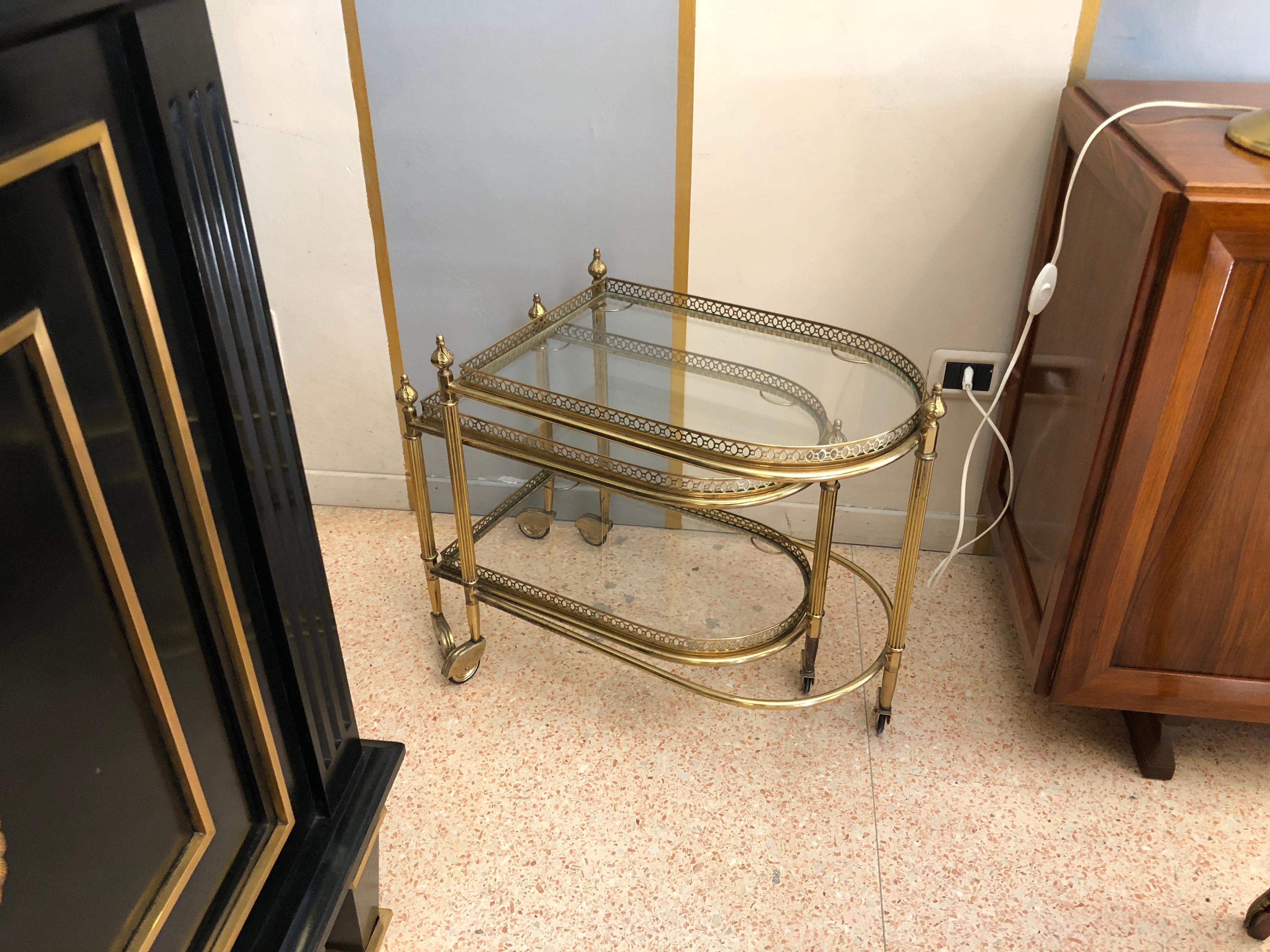 A tray composed by two pieces which can be easily moved thanks to the wheels. The structure is made of brass while the shelves are made of crystal.
The smaller tray has two shelves while the bigger one has only the top layer to allow the smaller to