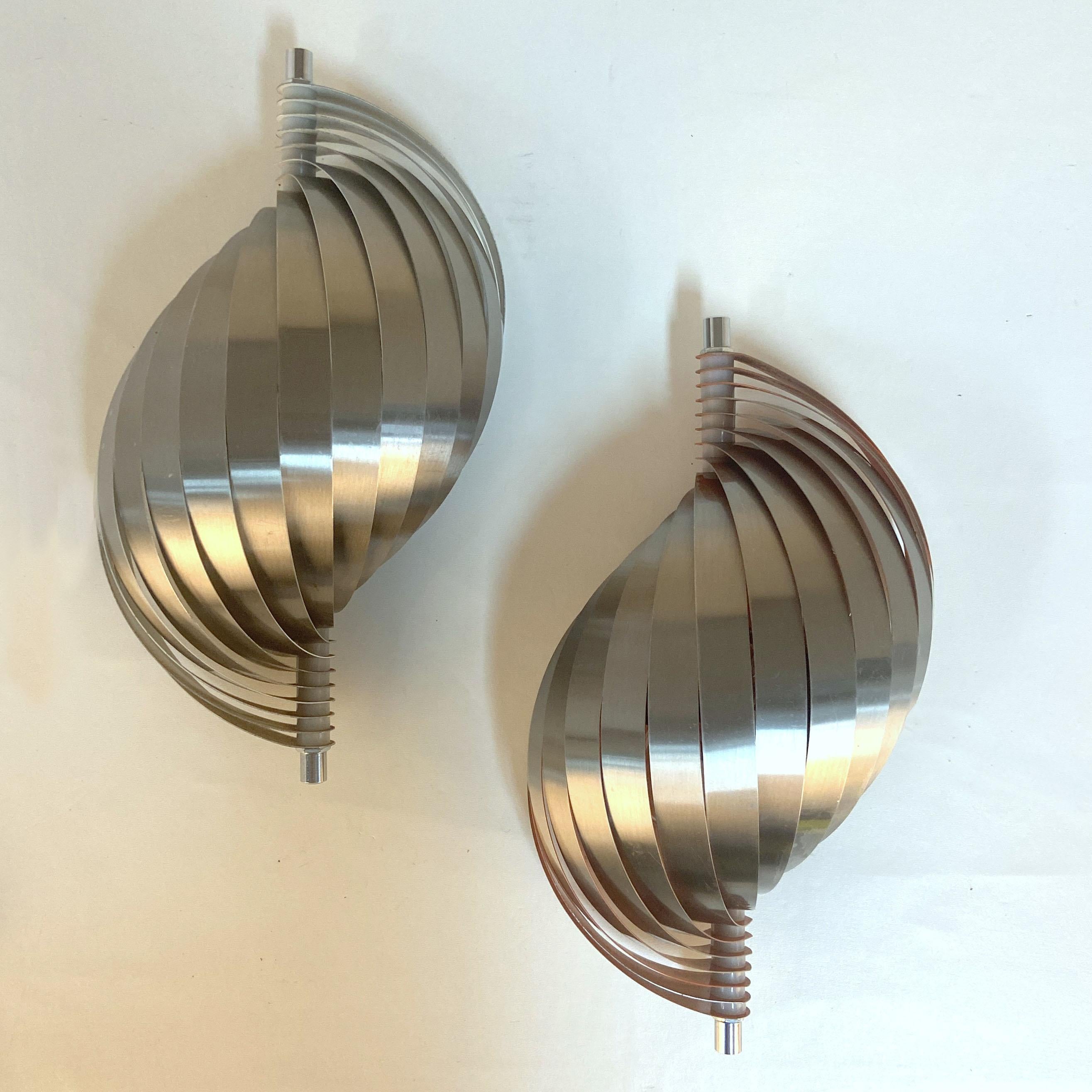 Spiral wall sconces in the style of Henri Mathieu were manufactured by The Massive Lighting Company in Wilrijk, Belgium 1970's.
One of these lights has a warm orange color inside and the other is white inside which influences the color of the light