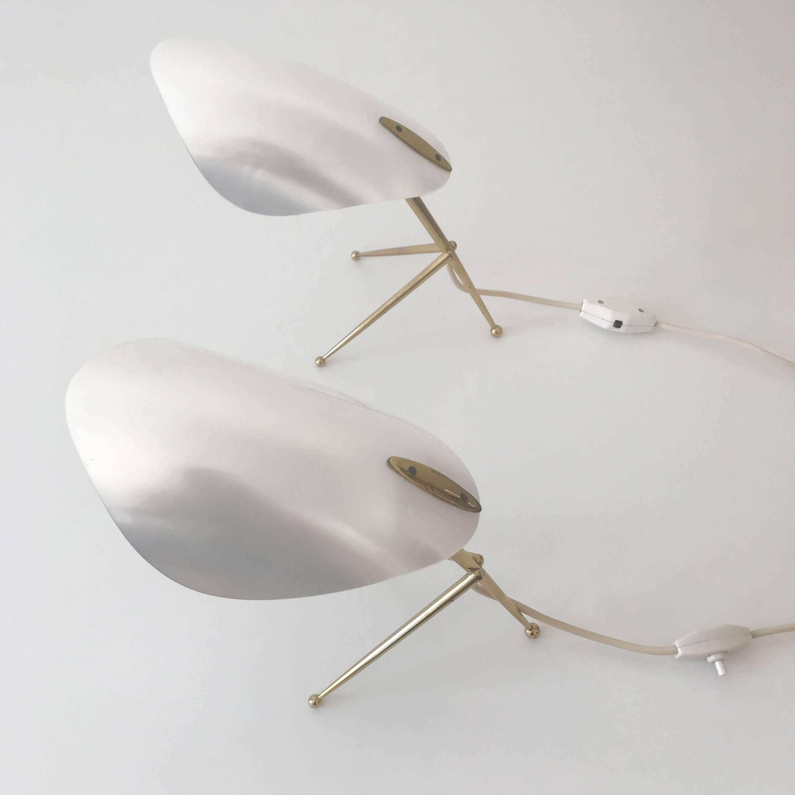 Two stunning Mid-Century Modern Sputnik table lamps. Manufactured probably by Kaiser Leuchten, Germany, 1950s.
These identical pair of table lamps are executed with tripod bases in brass and white Lucite shades which look like a mother-of-pearl.