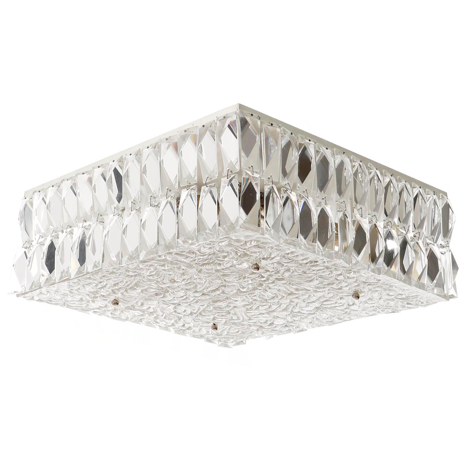 A square ceiling lamp by J.T. Kalmar, Vienna, Austria, manufactured in midcentury, circa 1960 (late 1950s or early 1960s).
The fixture is made of a square white painted metal frame which is decorated with two rows of faceted cut crystal glasses on