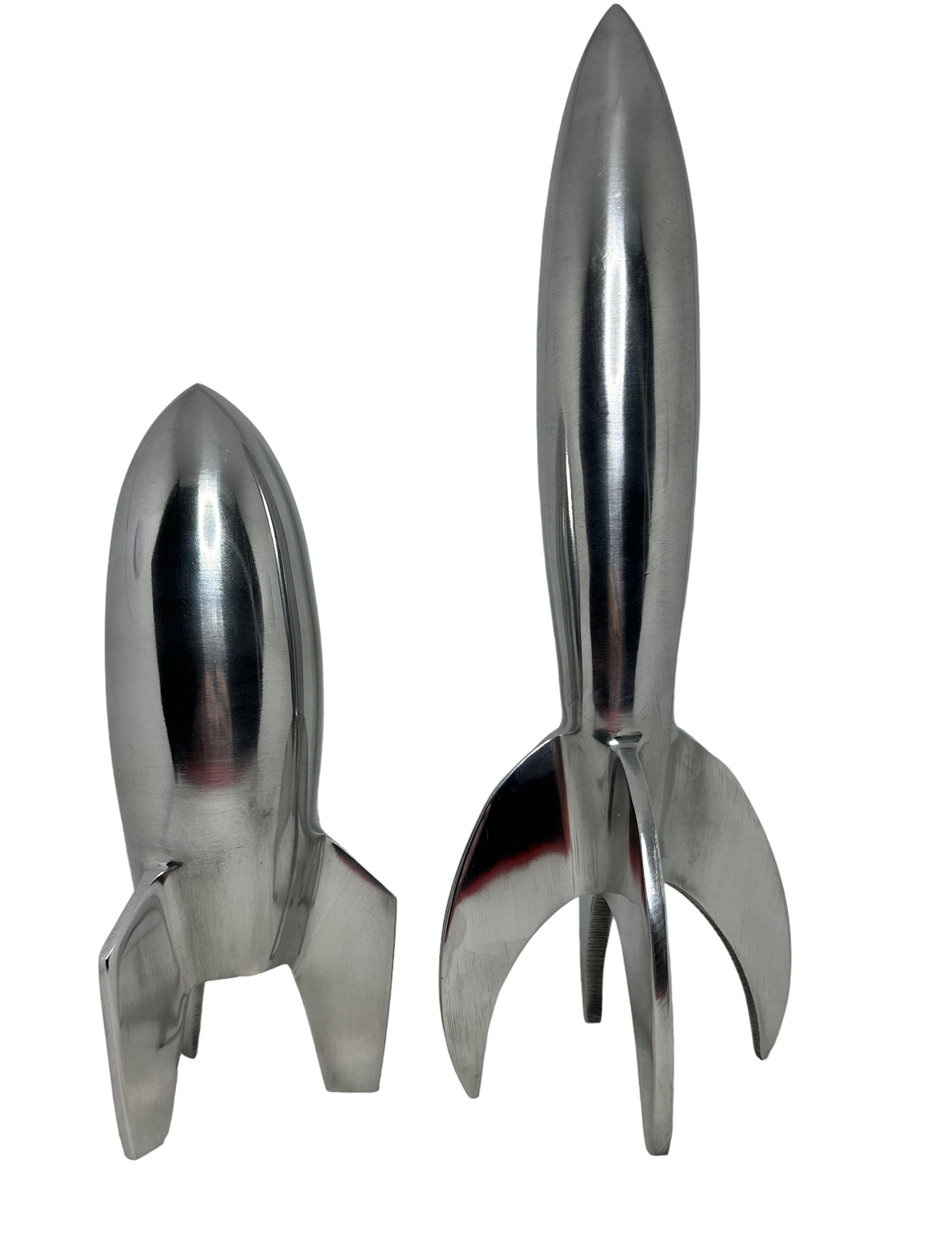 Scaled model of two Rocket statues. Hand-spun in metal. A nice architectural sculpture for every living room or console table. Tallest measures approximate 11.5