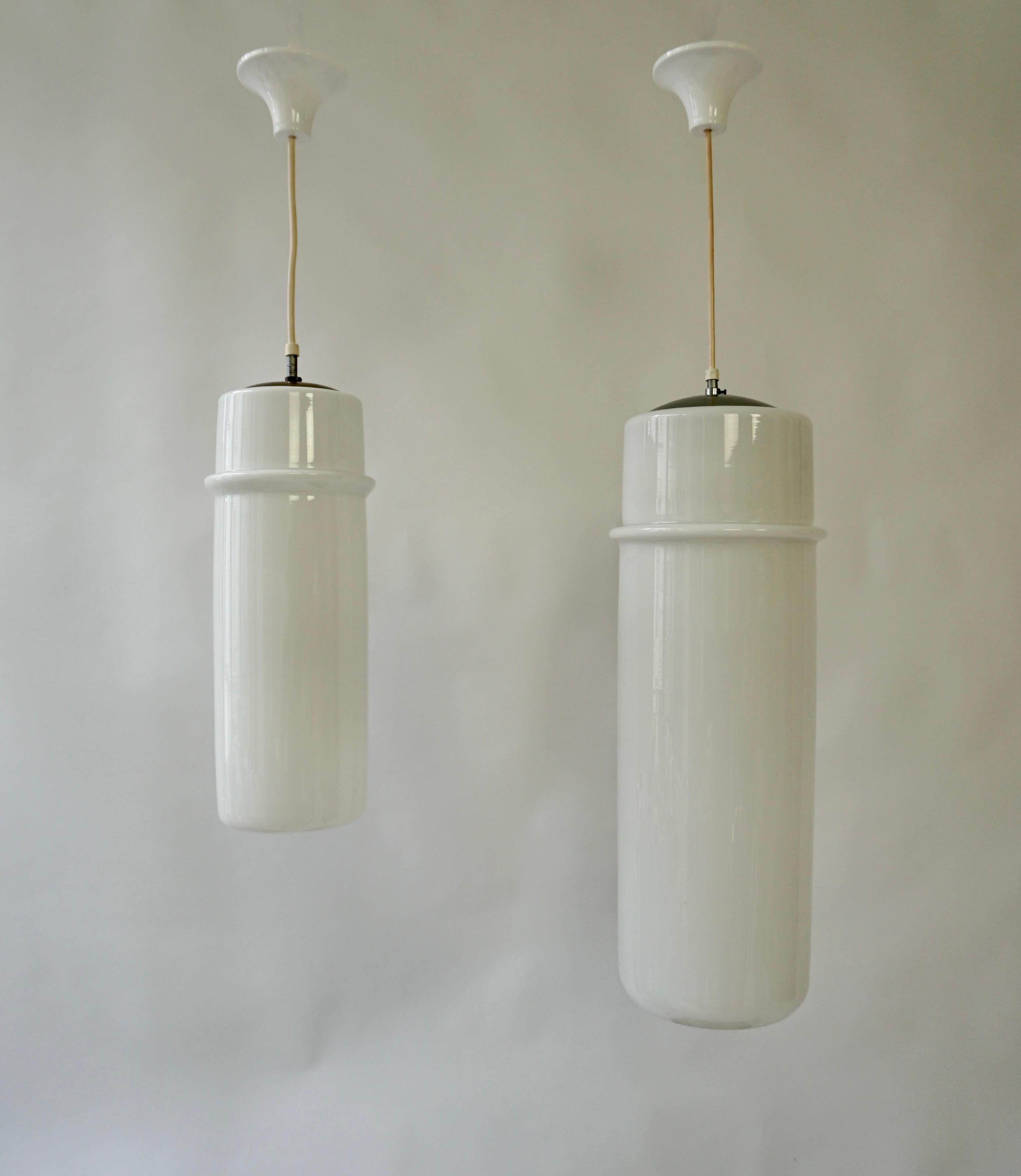 Two beautiful white Murano glass pendant lights with different lengths.
Italy, 1960-1970s.

The light has one socket for incandescent lamp with screw base or E27 type LEDs. It is possible to install this light in all countries (US, UK, Europe, Asia,