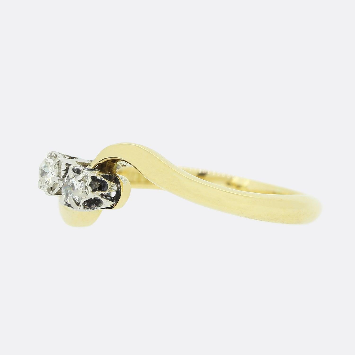 This is a classic 18ct yellow gold crossover ring featuring a round brilliant and a single cut diamond; each of which is claw set in platinum amidst a swirling band.

Condition: Used (Very Good)
Weight: 2.3 grams
Size: K
Total Diamond Carat Weight: