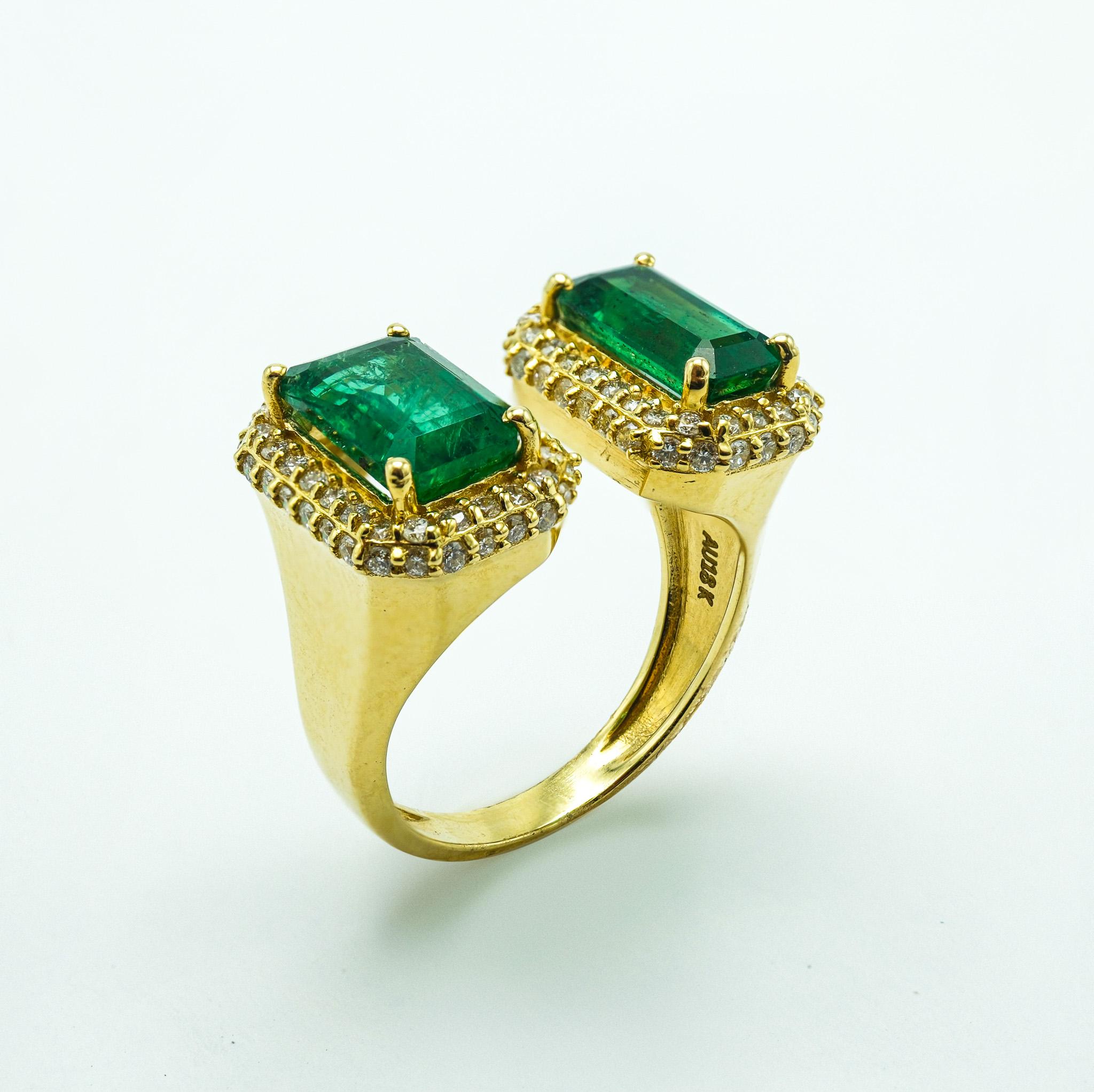 Modern Two-Stone Emerald and Diamond 18 Karat Yellow Gold Emerald Cut Ring For Sale