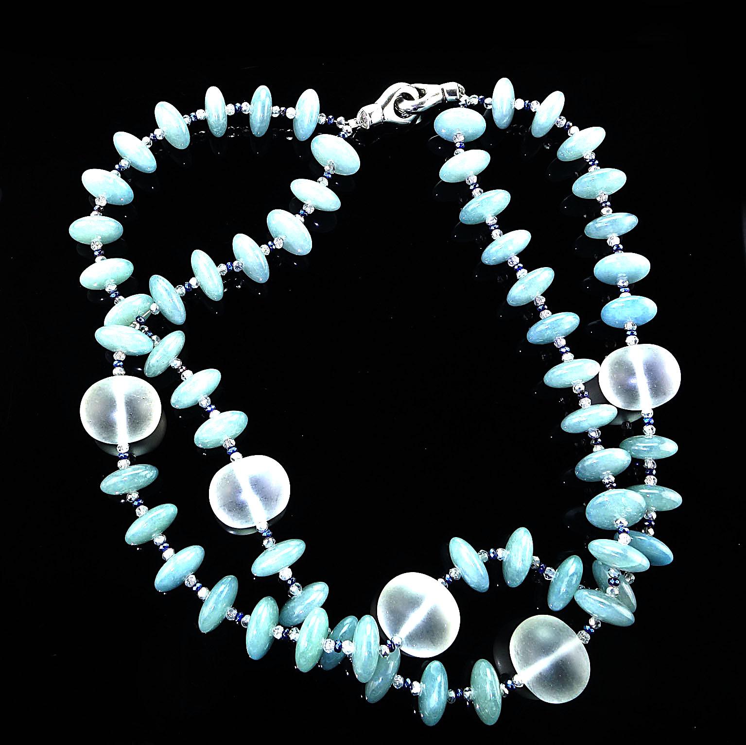 Translucent Sea blue Rondelles (11mm) of Aquamarine accented with Frosted Quartz Crystal (22mm) globes double strand necklace. This stylish necklace also features faceted blue and silver crystals to accent the Aquamarine rondelles. The necklace is