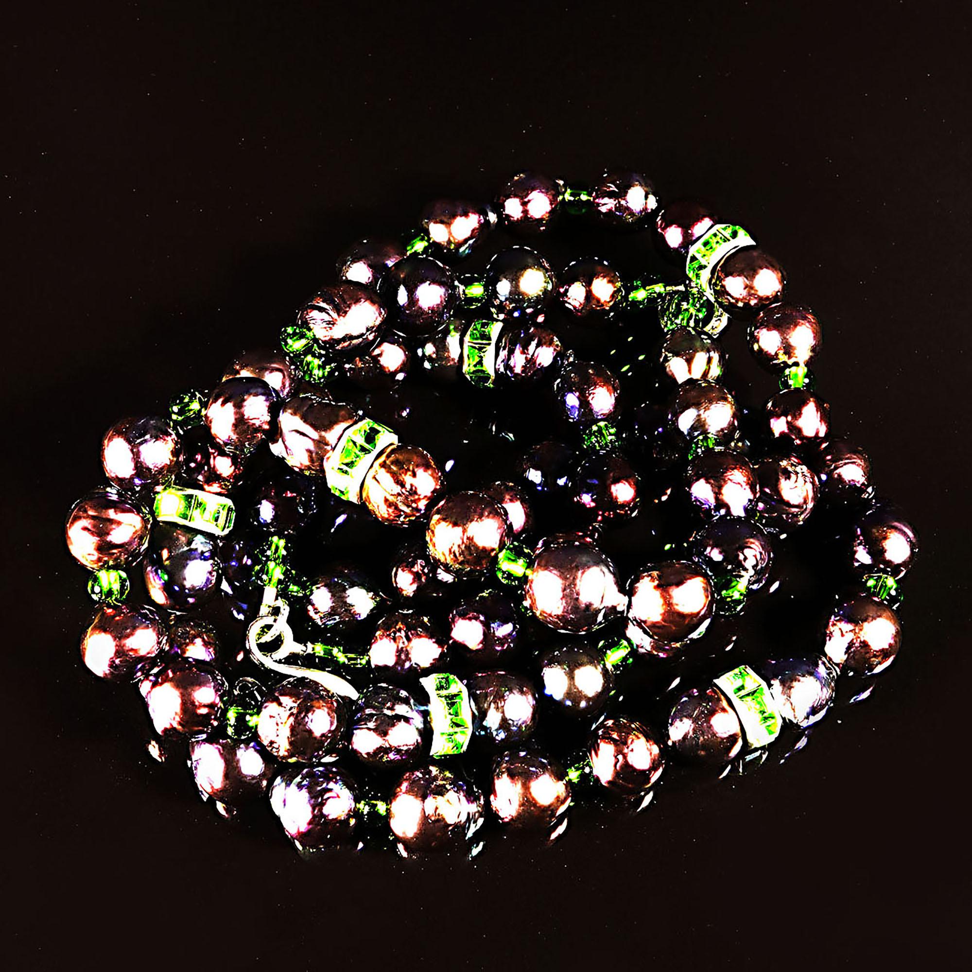 Own the pearls you deserve

Handmade, two strand, 16 and 18 inch, purple freshwater pearl necklace enhanced with bright green crystal rondelles and Czech beads. These iridescent pearls, 10MM, have a lovely flash which is complemented by the bright