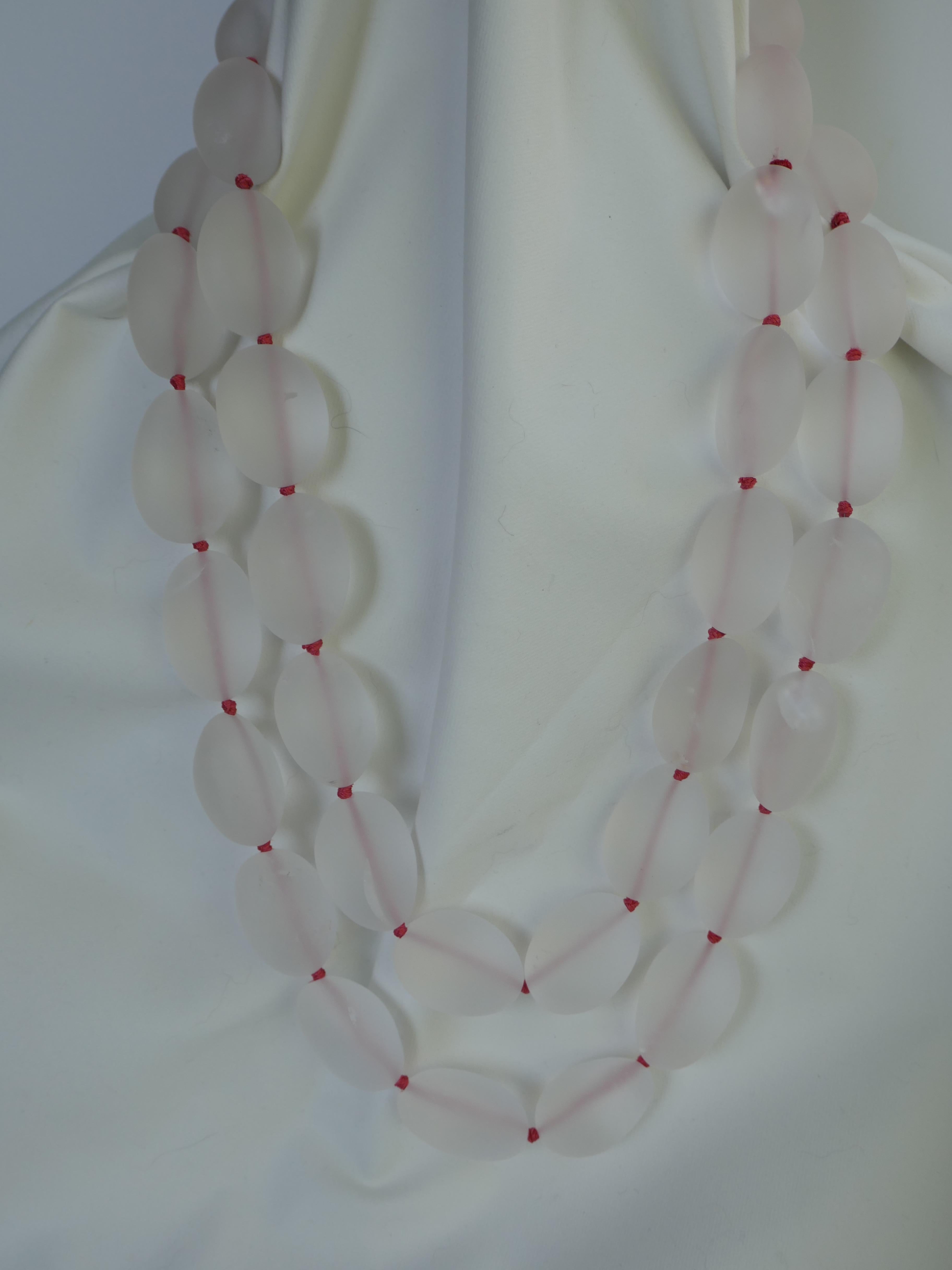 Love rock crystal!!! This necklace is spectacular.... It is knotted on coral color silk thread making the frosted matted rock crystal stand out. The photos do not capture the beauty of  this necklace. I love matted cracked rock crystal specially the