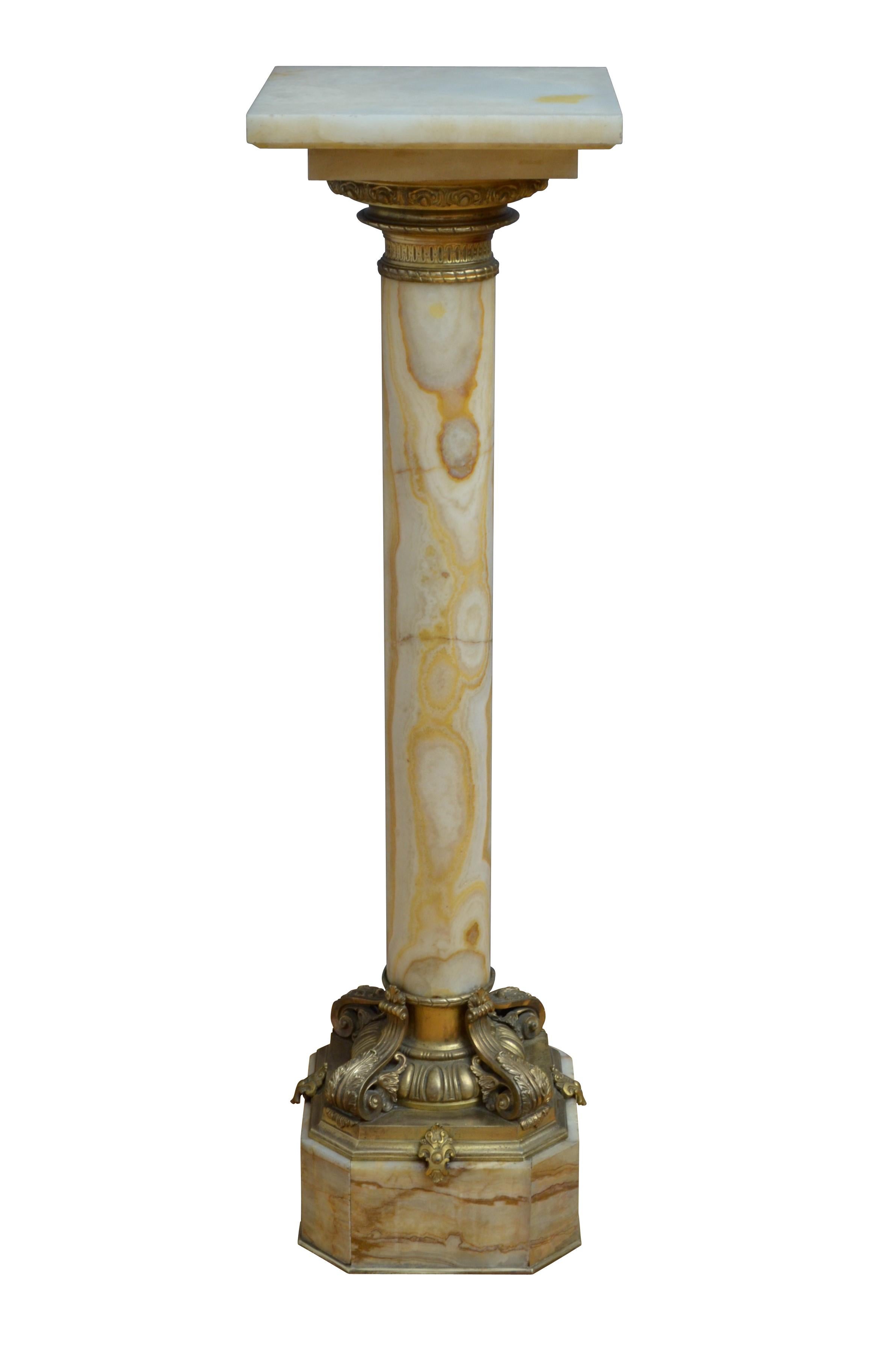 Matched pair of exquisite 19th century onyx pedestals each with revolving top with ormolu collar below, substantial column with variety of colours terminating in most beautiful base with egg and dart decoration and four scrolled leaves, standing on