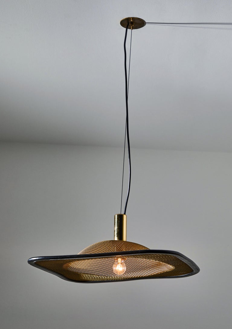 Two suspension lights by Reggiani. Designed and manufactured in Italy, circa 1960s. Brass mesh, enameled metal. Rewired for US junction boxes. Each light takes one E27 75w maximum bulb. Bulbs provided as a one time courtesy. Embossed with original