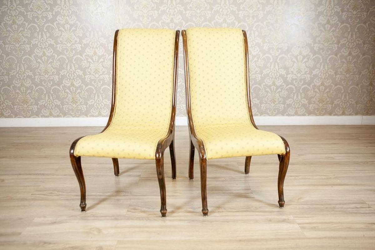 Two Swan Armchairs in Yellow Upholstery, Late 19th Century

A sophisticated pair of French Swan Chairs in the Louis XV style, featuring gracefully curved wooden frames with a rich, dark patina. The high, sweeping backs and gently sloping seats