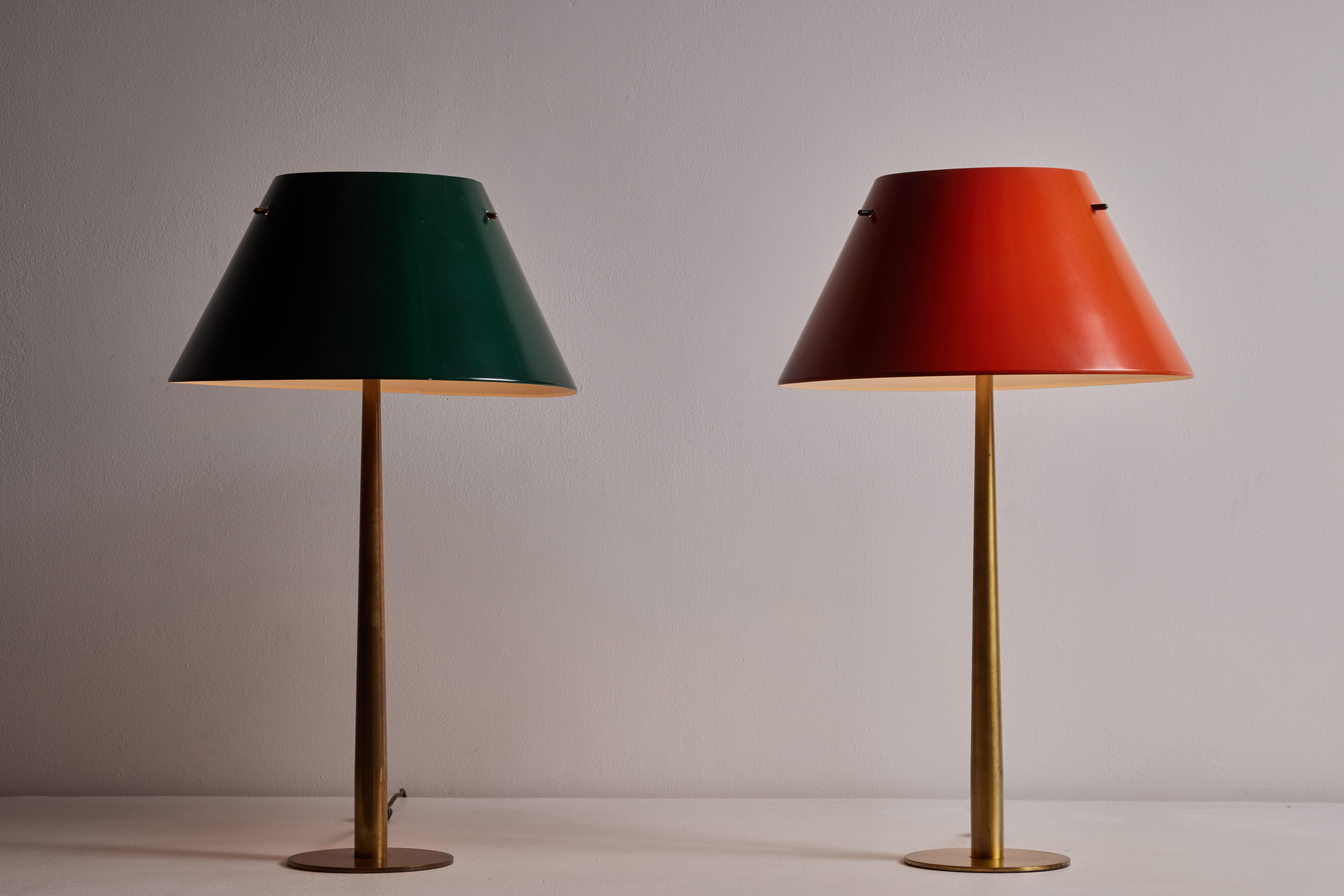 Two table lamps by Hans Agne-Jakobsson for Markaryd. Designed and manufactured in Sweden circa 1950's. Painted metal, brass. Original cord. Retains original European cord. We recommend one E27 100w maximum bulb per fixture. Bulbs provided as a one