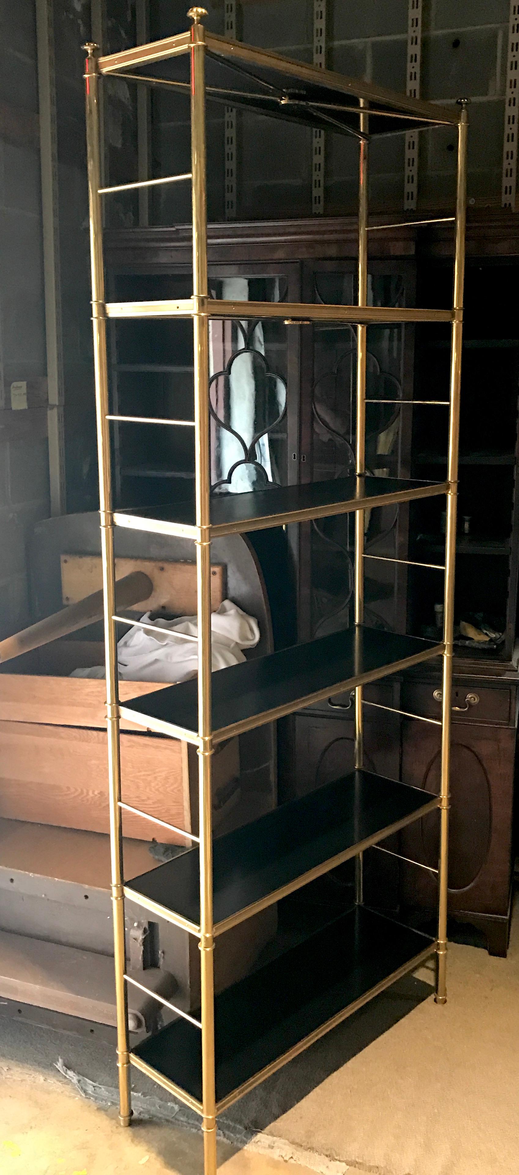 Tall elegant etagere or bookcase designed by Billy Baldwin for Cole Porter, designed by Frederick Victoria, Seven ebonized wood shelves rest in an engine turned brass frame. All adjustable and assembled. 


 