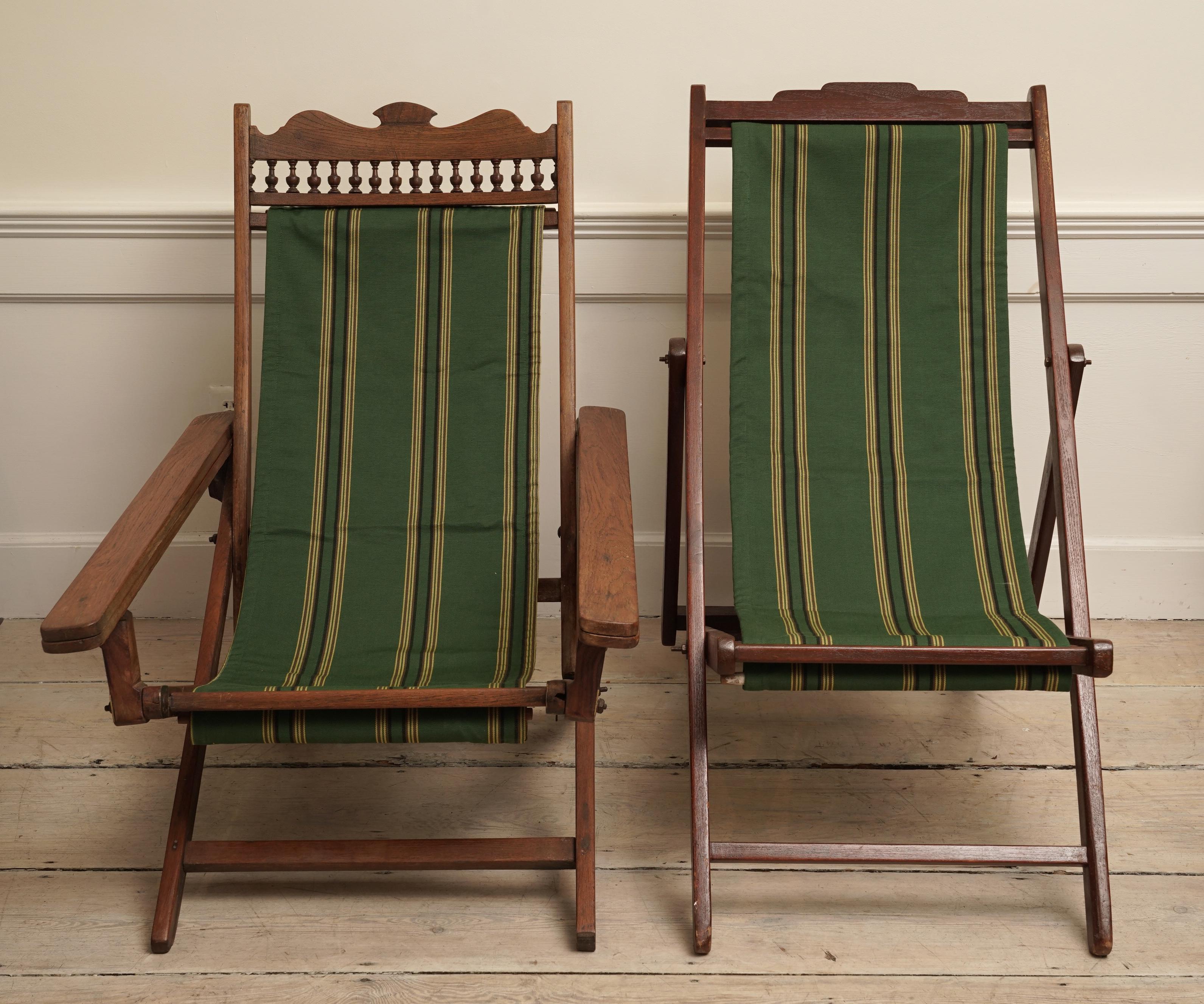 Not exactly a pair, more like cousins or his and hers--British Colonial folding teak wood canvas chairs from the 1940s. Both have height adjustments and the larger one has slide-out leg rests in order to put your feet up. The canvas has been