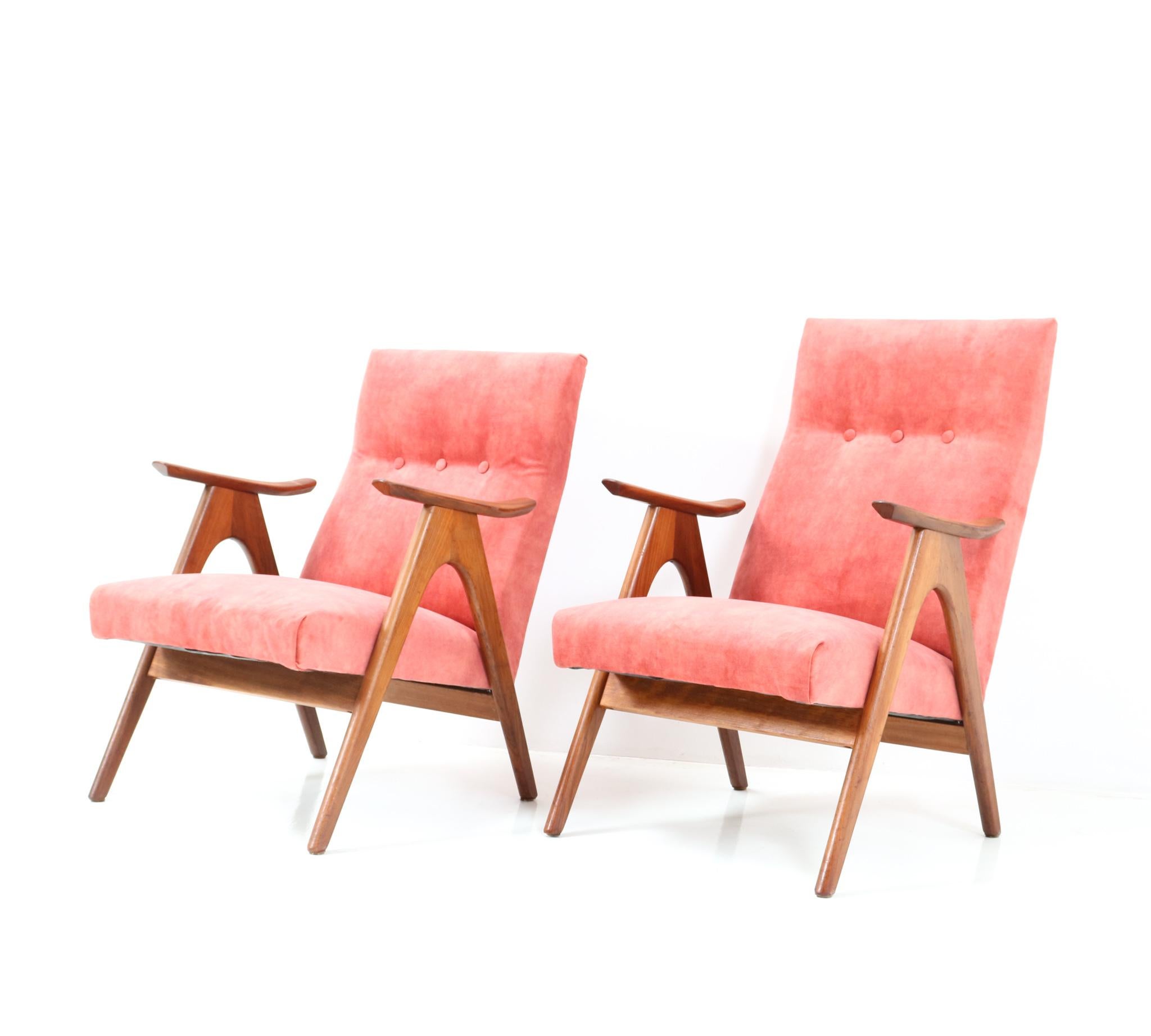 Stunning and elegant pair of Mid-Century Modern lounge chairs.
Striking Dutch design from the 1960s.
Solid teak frames and re-upholstered with a velvet kind of fabric.
Dimensions of the ladies chair: H: 80,5 cm or 31.69 in.W: 60.5 cm or 23.82