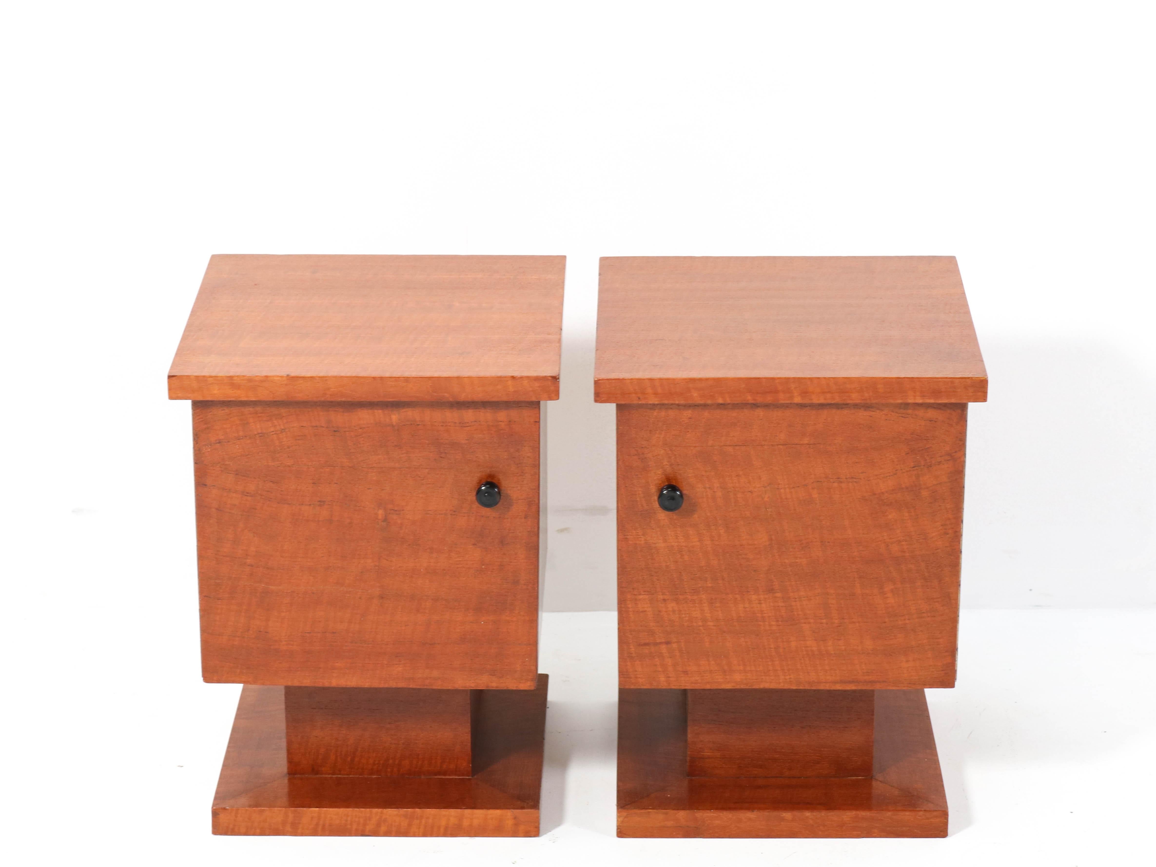 Wonderful pair of Mid-Century Modern nightstands or bedside tables.
Striking Dutch design from the 1950s.
Solid teak and original teak veneer with original ebony knobs.
Marked with manufacturers stamp on the backside.
In very good refinished