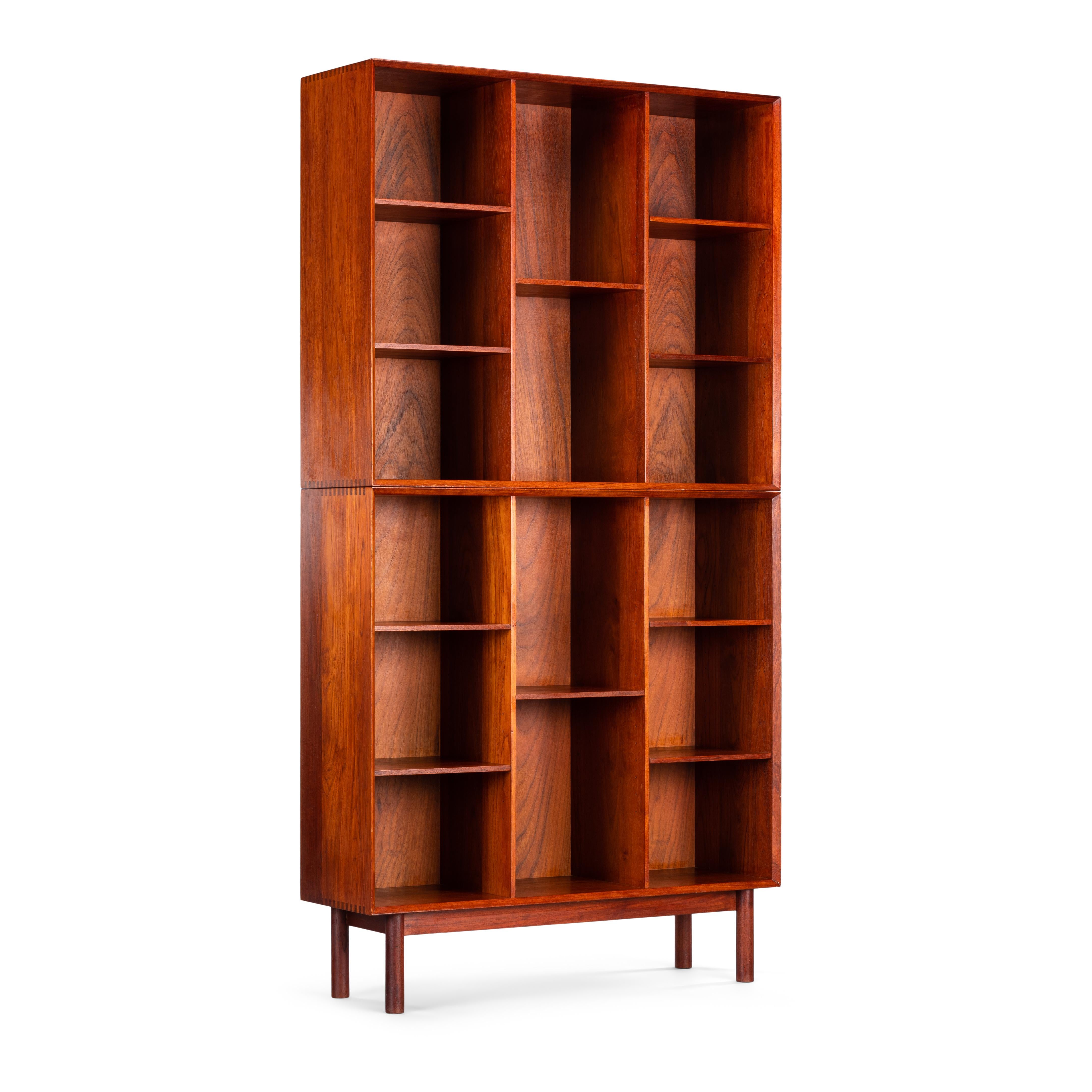 Fantastic two tear teak bookcase by Peter Hvidt and Orla Mølgaard for Soborg Møbler. This bookcase consists of a top and bottom case of equal dimensions. Each case has mitered edges, the 'can I have some please' finger joints and the fully
