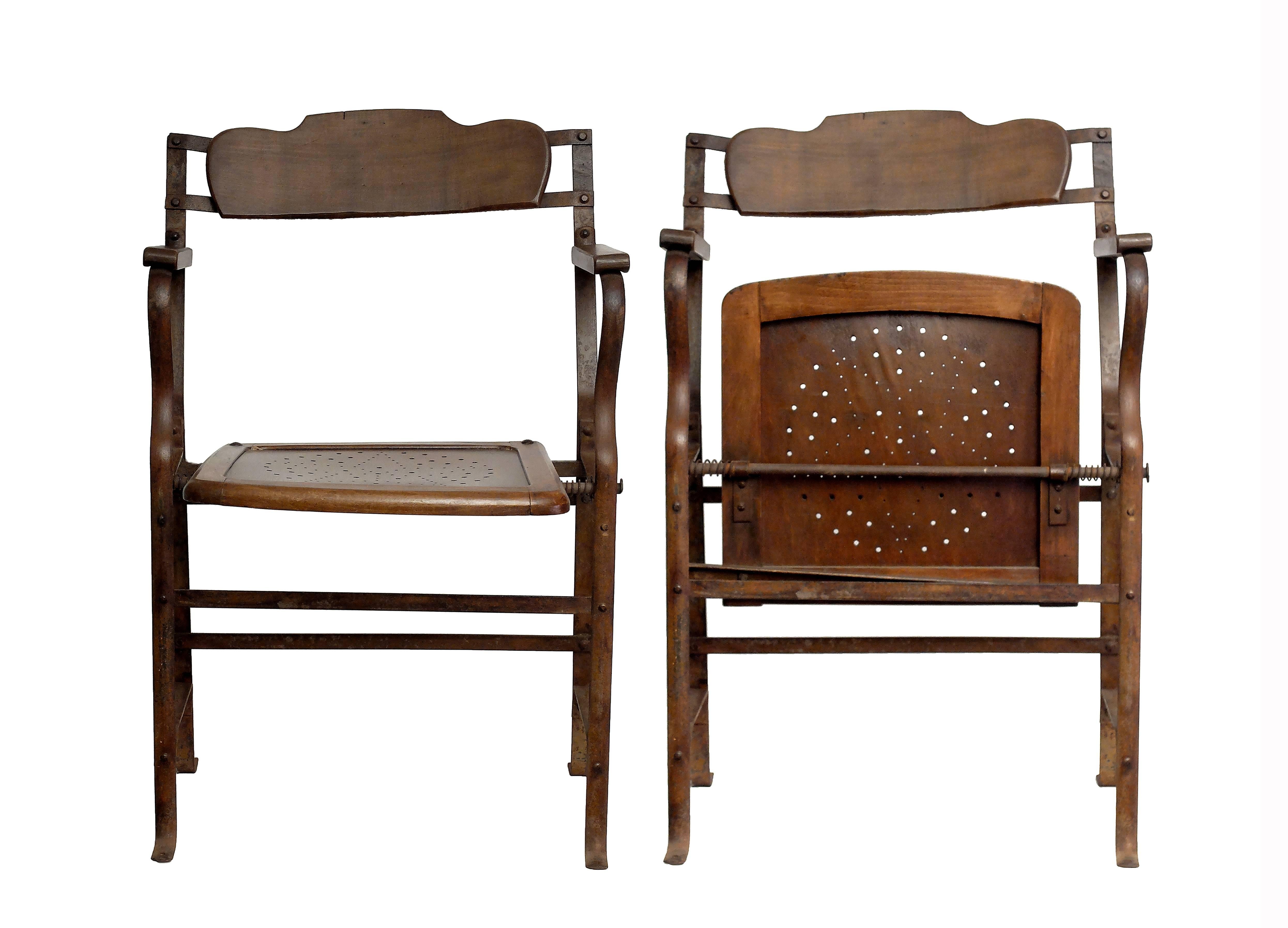 The two unusual theatre chairs are made out of wood and iron,
spring activated wooden seat and moved profile wooden backrest.
Excellent patina. France, circa 1920. Sold also separately. Price is intended per one chair.