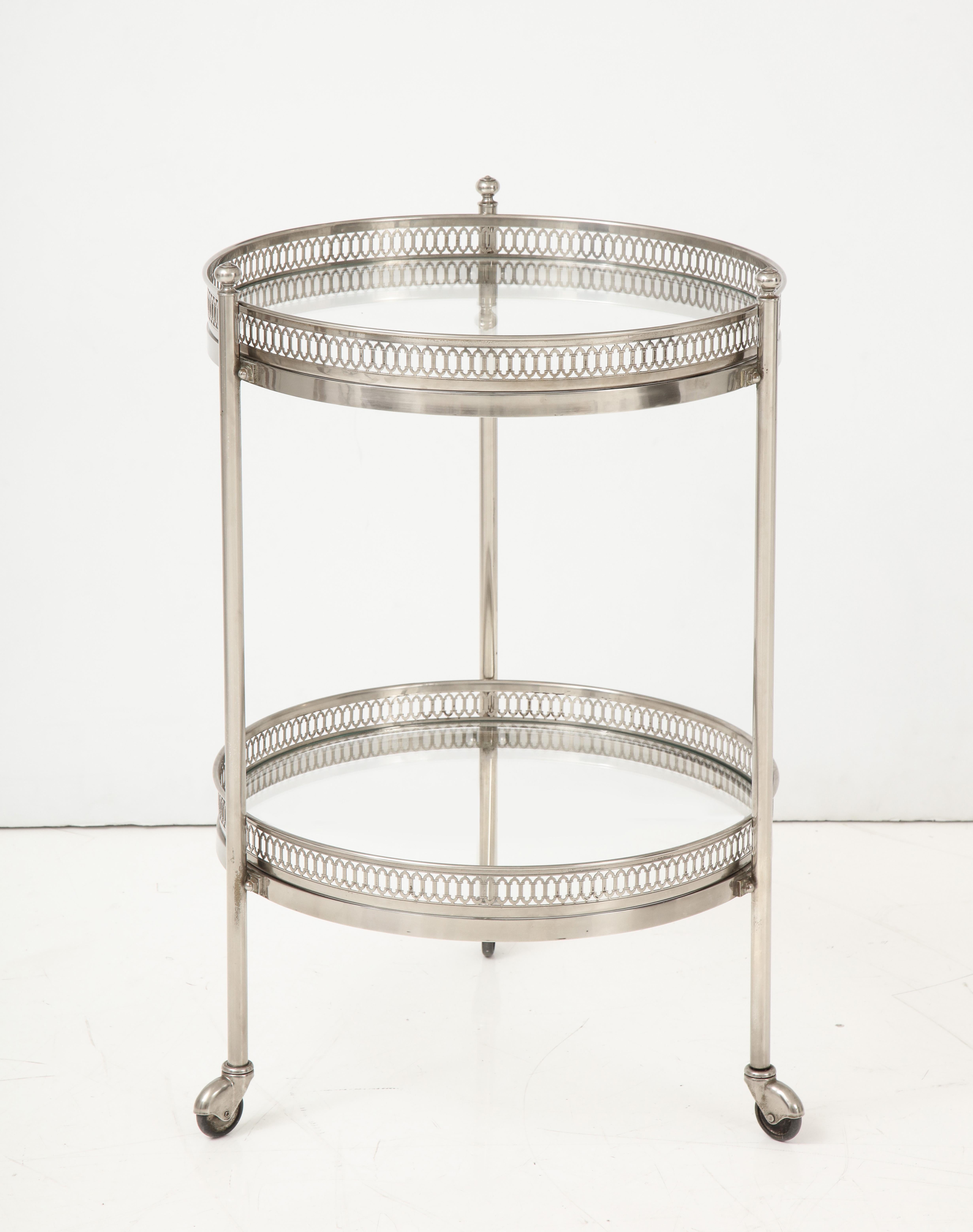 Who doesn't love a bar cart? We chose this one for its round shape and design. Finished in polished nickel, this little gem features two levels, each surrounded by a detailed gallery, and three legs on castors. Perfect for a small space!