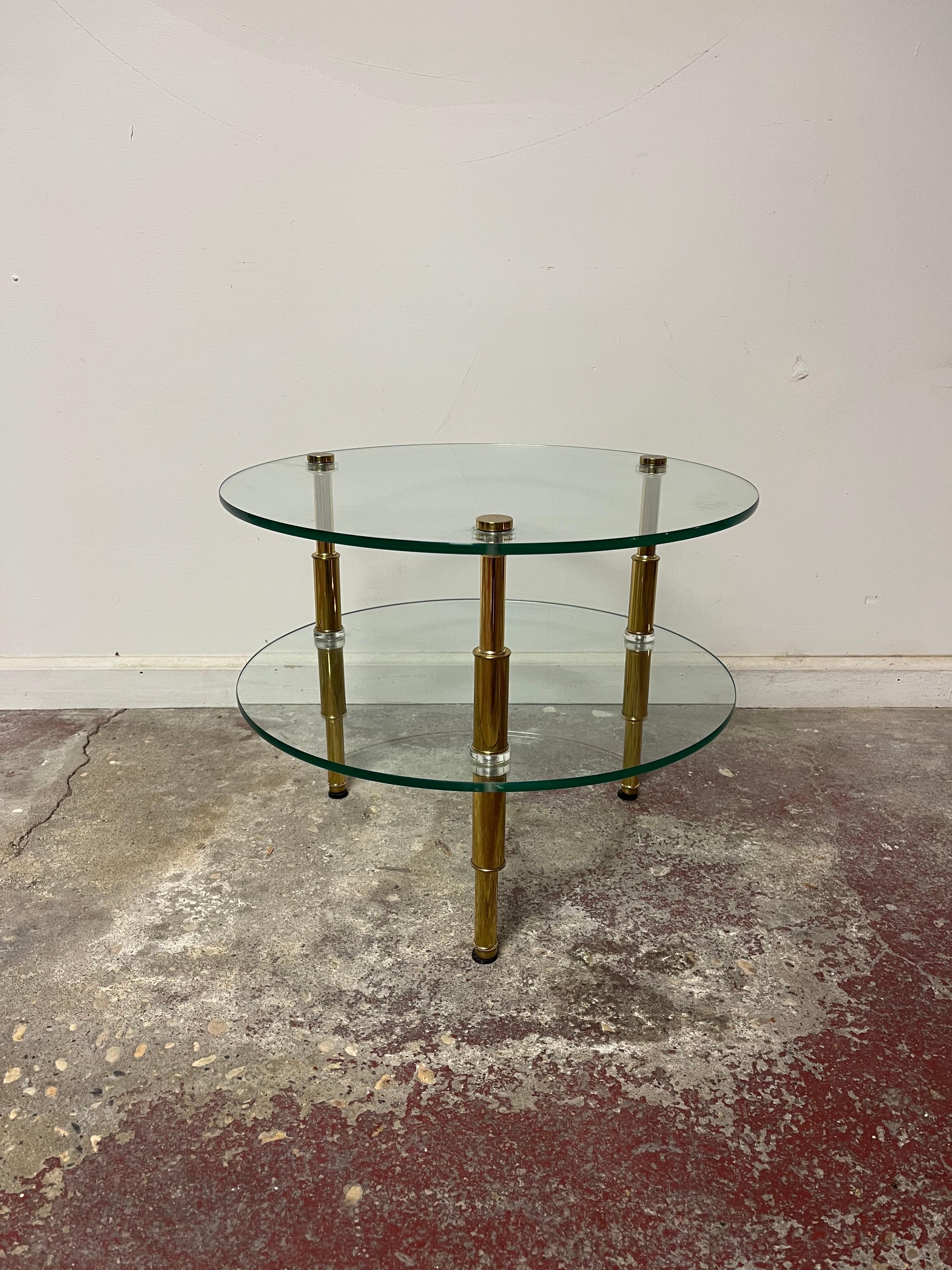 Beautiful occasional table. Brass legs with a tapered design and a modern bamboo look. 2 glass shelves with brass caps. Lucite spacers for added visual impact. High quality, heavy, possibly Italian. 
Curbside to NYC/Philly $350