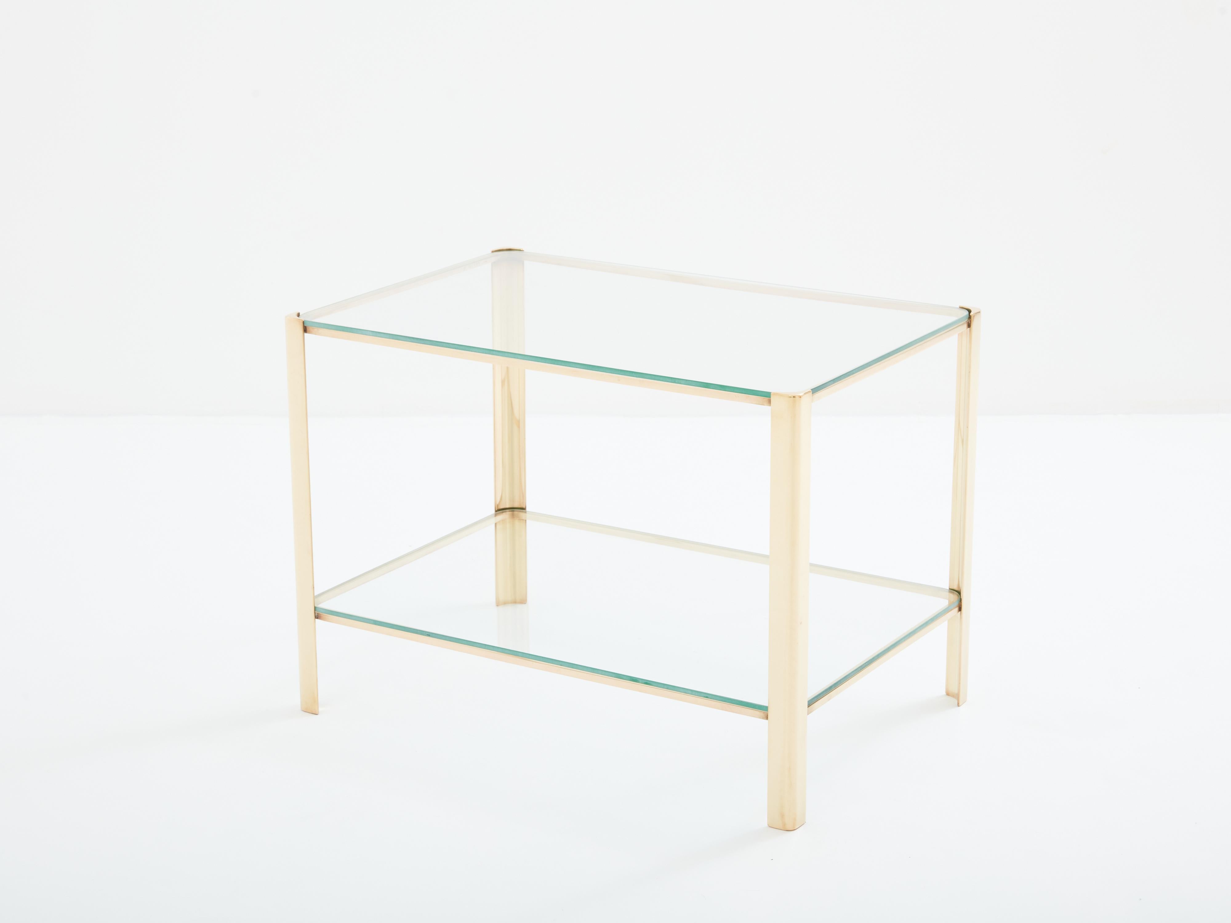 This beautiful two-tier side table was designed by Jacques Quinet and produced by Broncz in France in the 1960s. This side table features a strong, solid polished bronze structure built to last forever. The two original transparent glass tops add a