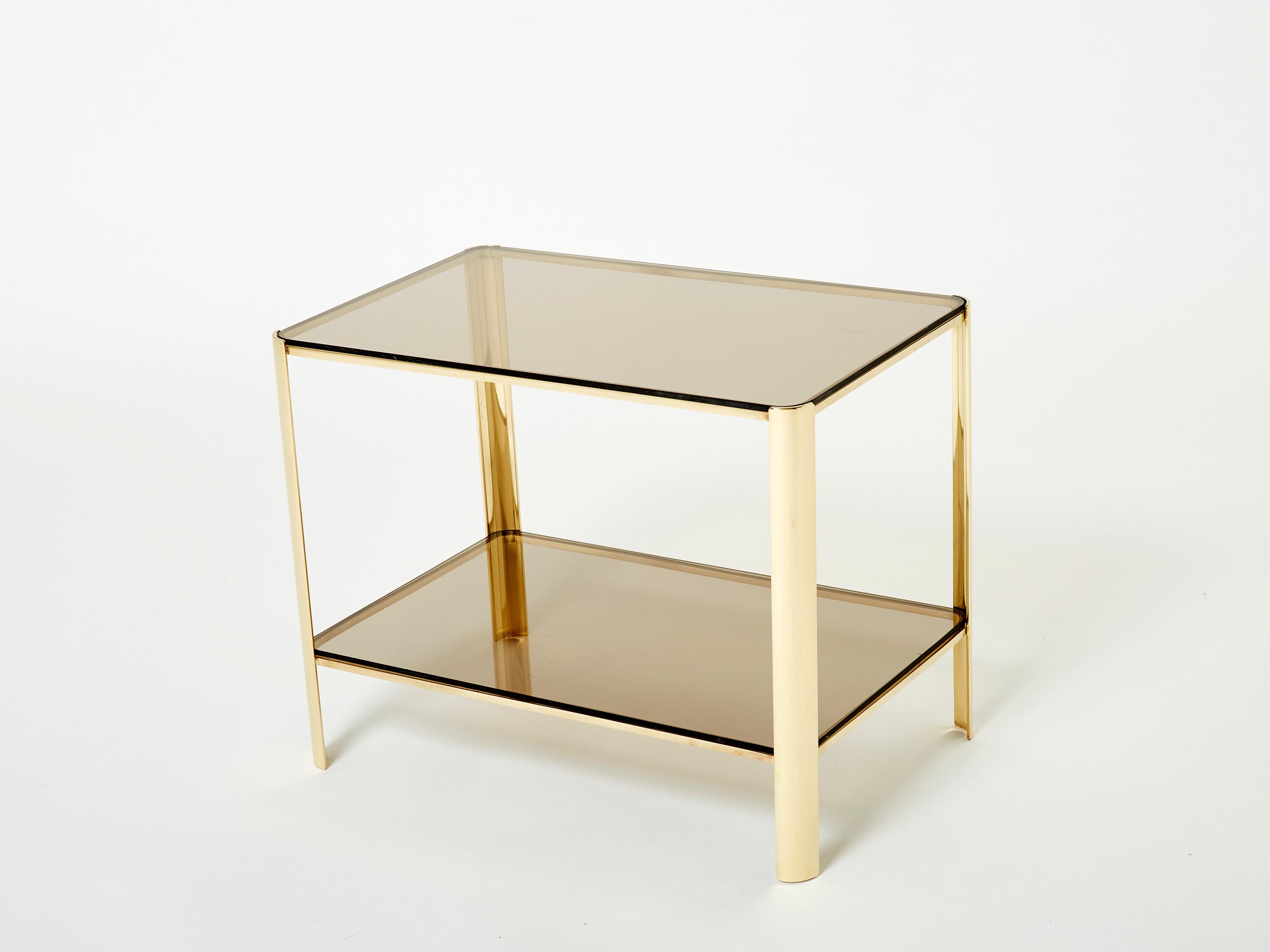 This beautiful two-tier side table designed by Jacques Quinet and stamped by Broncz, is a beauty. The table features a strong, solid polished bronze structure built to last forever. The two original brown smoked glass tops add a nice aesthetic