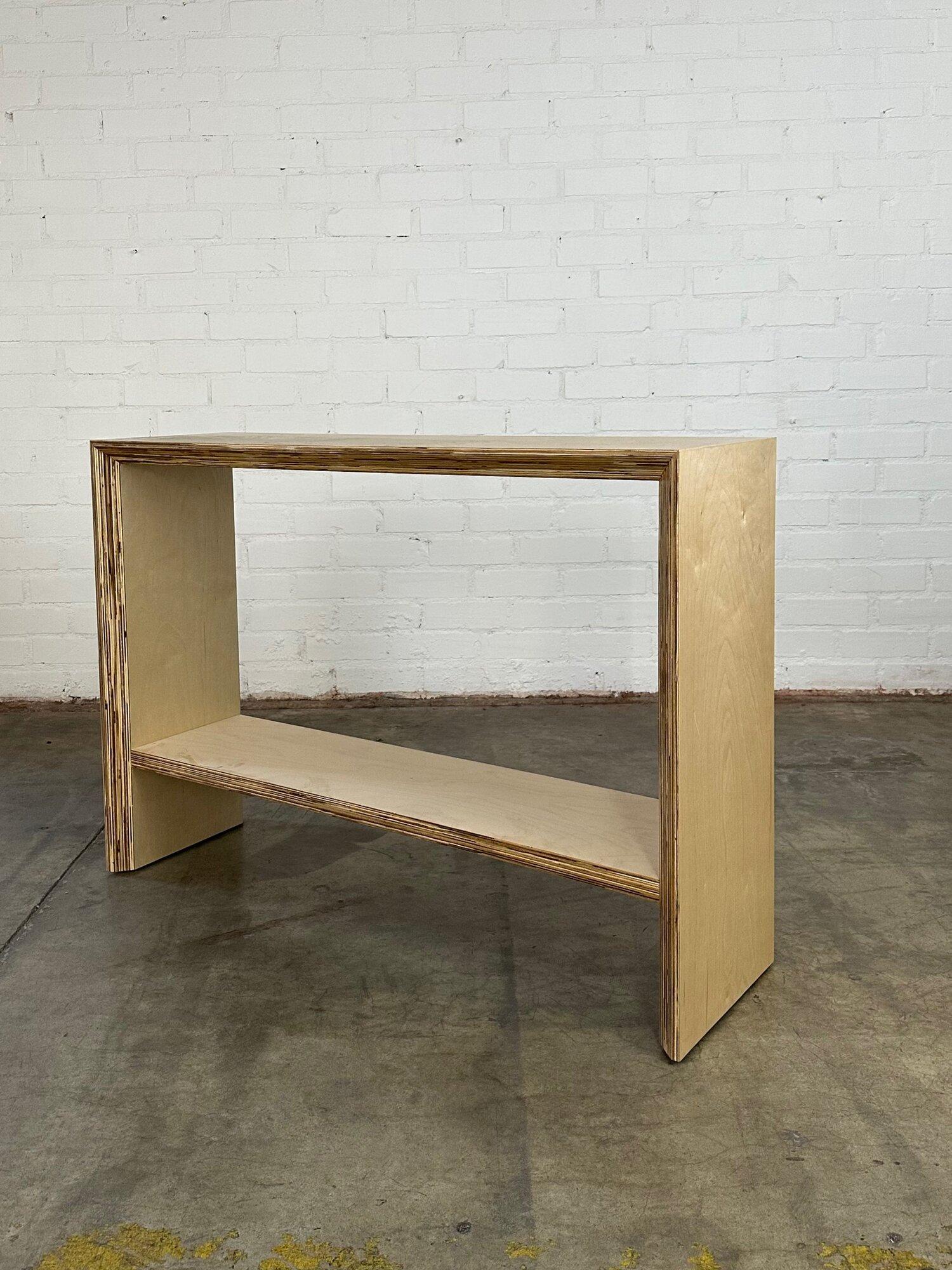 W50 D15 H35

Handcrafted in house this minimal Maple plywood console is made to order. Item features slight angled sides and exposed plywood sides to add a flair of detail. Item is structurally sound and super sturdy. Price is for the floor model