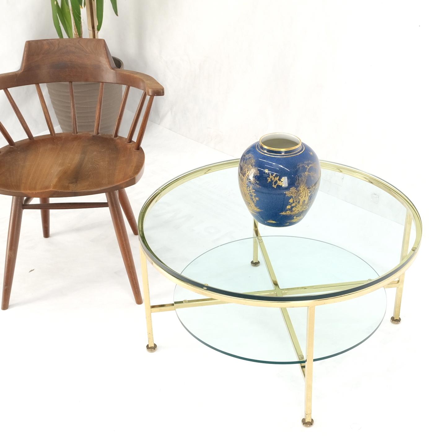 Two tier cross shape brass base round occasional coffee side end table stand.
Paul McCobb style - attributed.