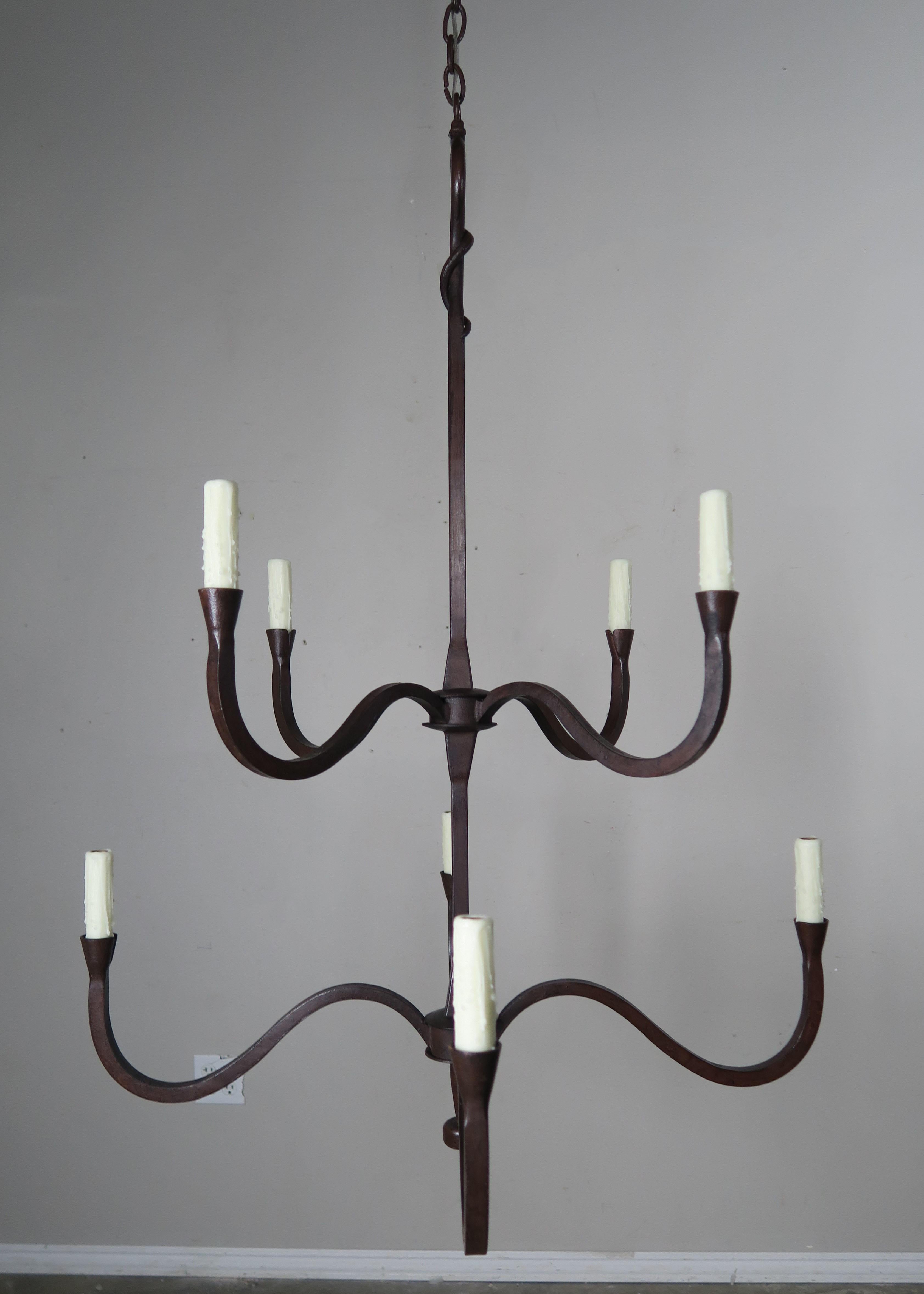 Two-tier eight-light handwrought iron chandelier finished in an antique iron finish. The chandelier is newly wired with cream drip wax candle covers. The chandelier is made in two sizes but any size or custom finish can be done per your