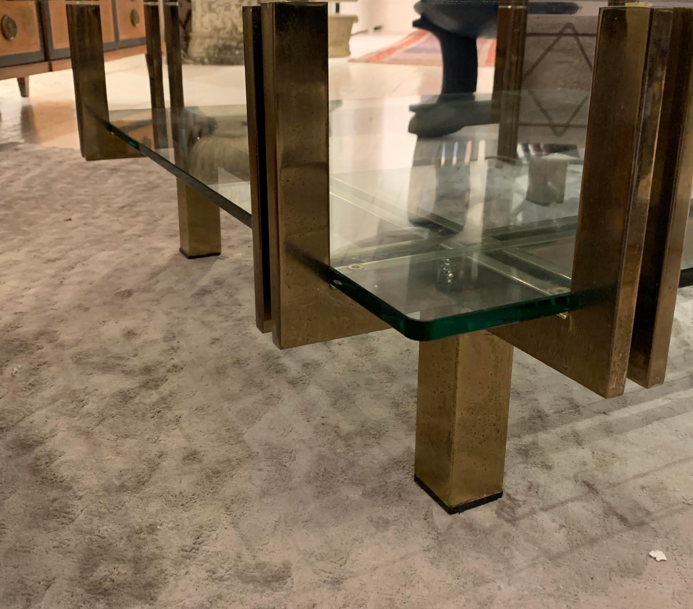 Midcentury Italian two-tier glass coffee table with polished nickel base.
Top tier extends past lower tier.
Glass top has minor scratches due to age and use.
 