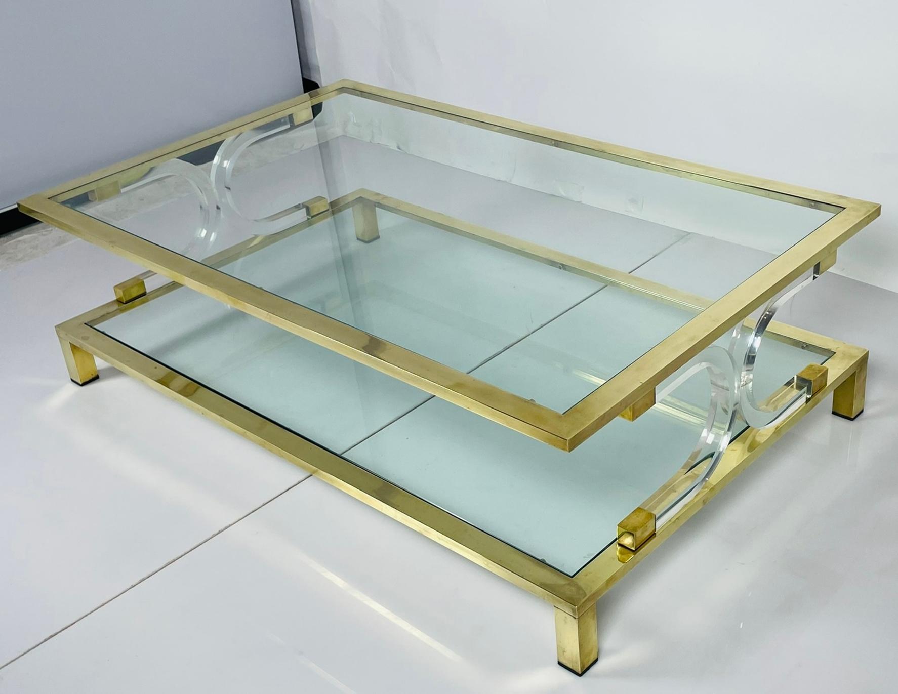 USA 1970's.

Introducing our exquisite Two Tier Lucite & Brass Coffee Table in the Style of Charles Hollis Jones, a stunning addition to any contemporary or modern living space. Crafted with meticulous attention to detail, this coffee table