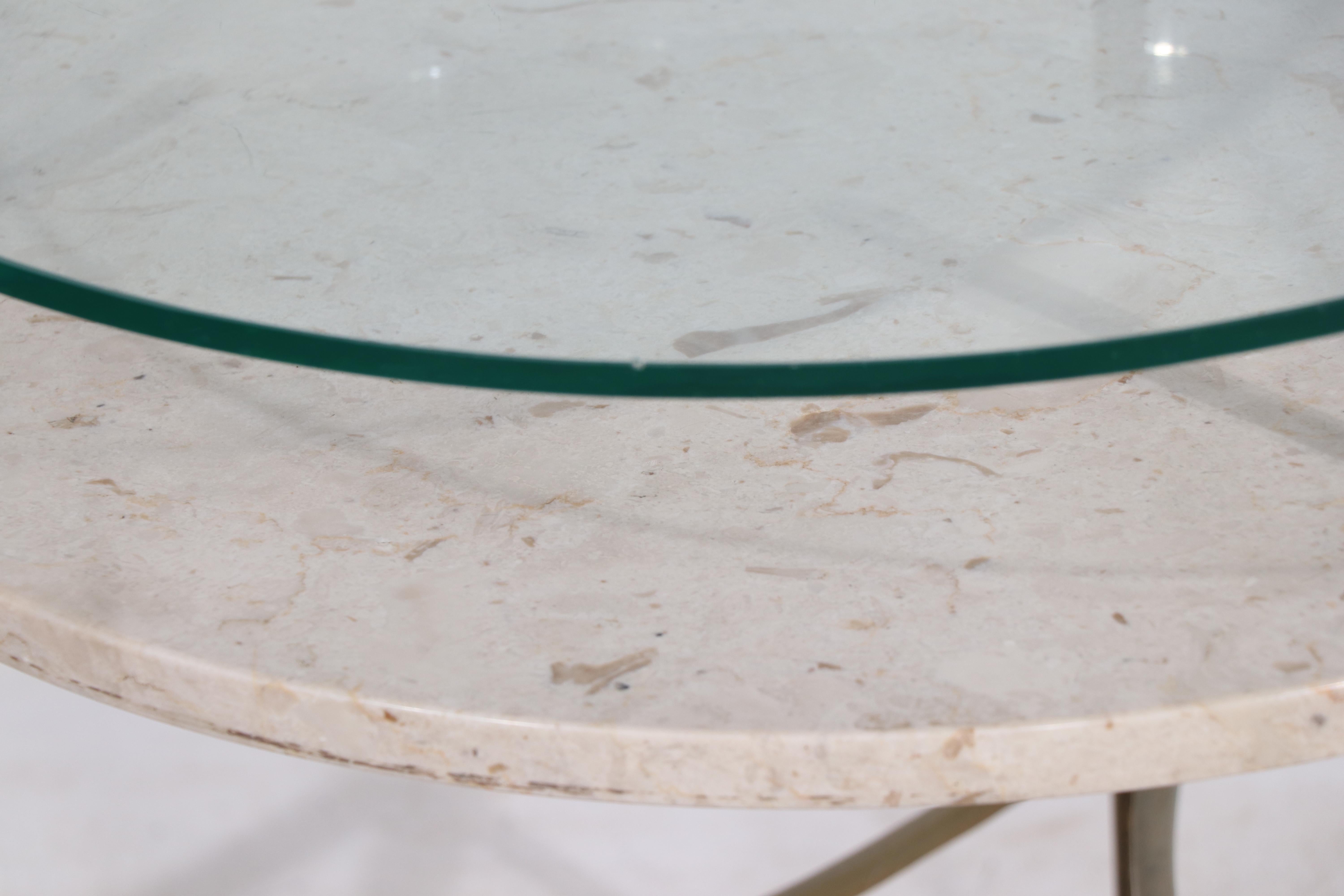 Chic, architectural two tier side table having a plate glass top, over a second level marble shelf, all supported by brass vertical elements.
The top glass shelf is 23.5 H, lower marble shelf 20 H, glass shelf has an inconsequential pin flake flaw