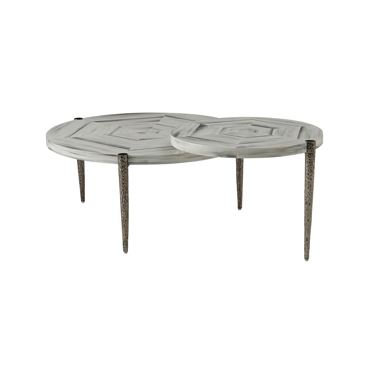 Two hand-painted faux horn rayed symmetrical tops with natural cast textured hammered metal bases. This cocktail table is sure to become the focal point of any living room.

Dimensions: 50
