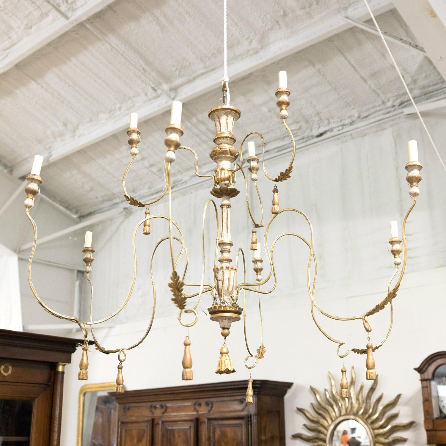 A painted and parcel gilt French chandelier hand made in France from 18th century parts having two tiers and nine lights. This beautiful chandelier features a central turned and fluted wooden column adorned with giltwood foliate and beaded elements.
