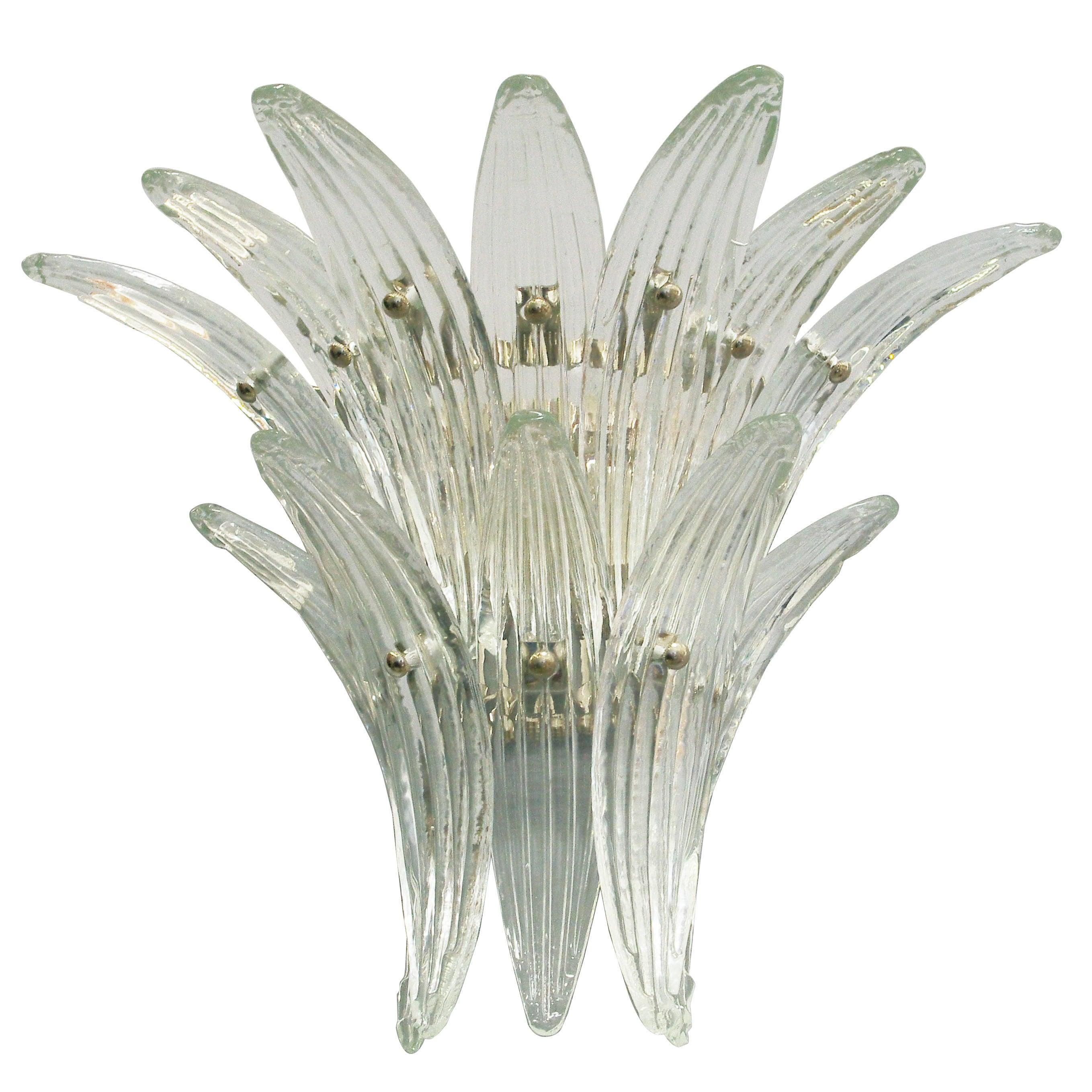 Italian Palmette wall light with 12 clear Murano glass leaves mounted on chrome finish metal frame. Designed by Fabio Bergomi for Fabio Ltd / Made in Italy
2 lights / E12 or E14 type / max 40W each
Measures: Height 15 inches, width 19 inches, depth